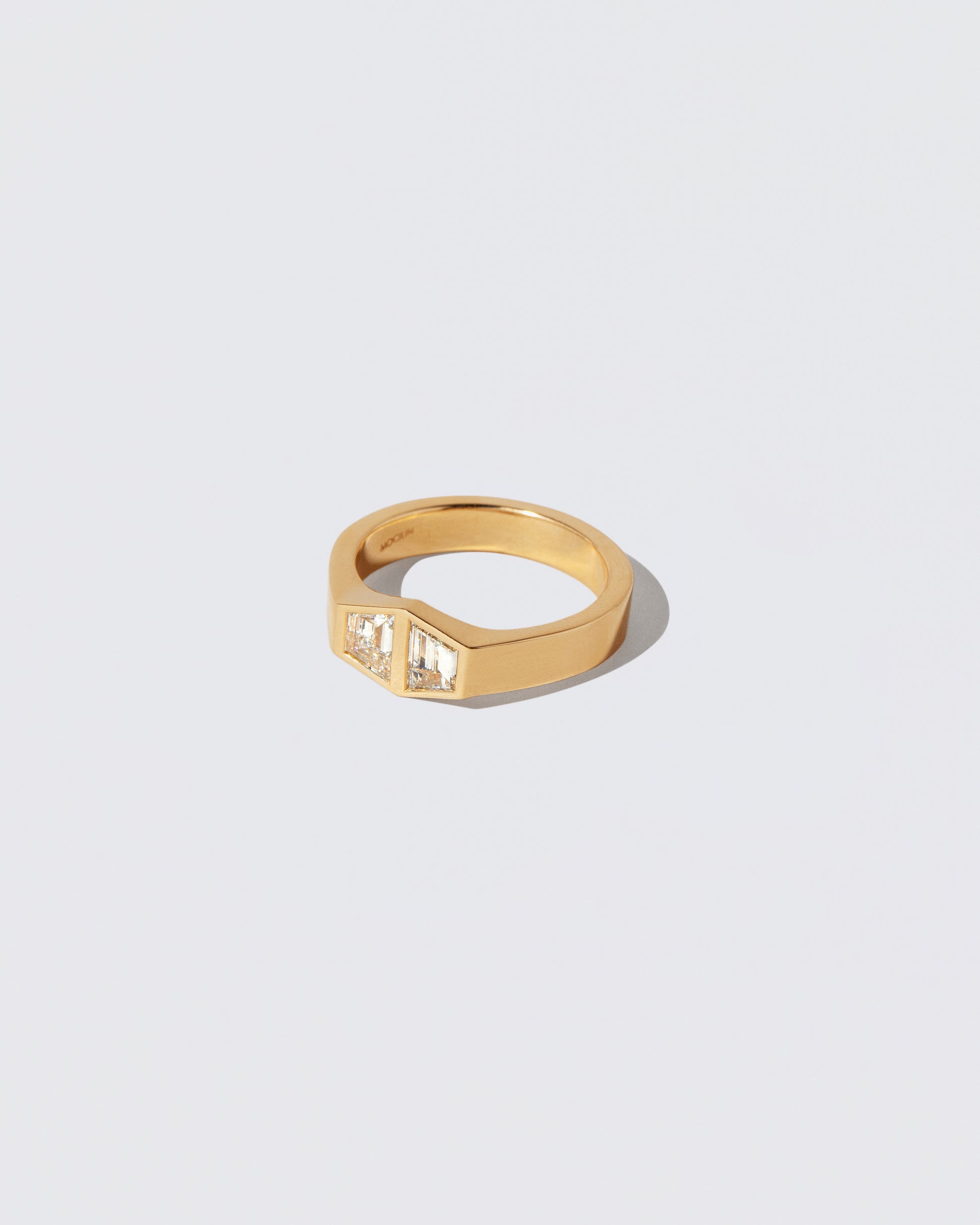 View from the side of the Miroir Ring on light color background.