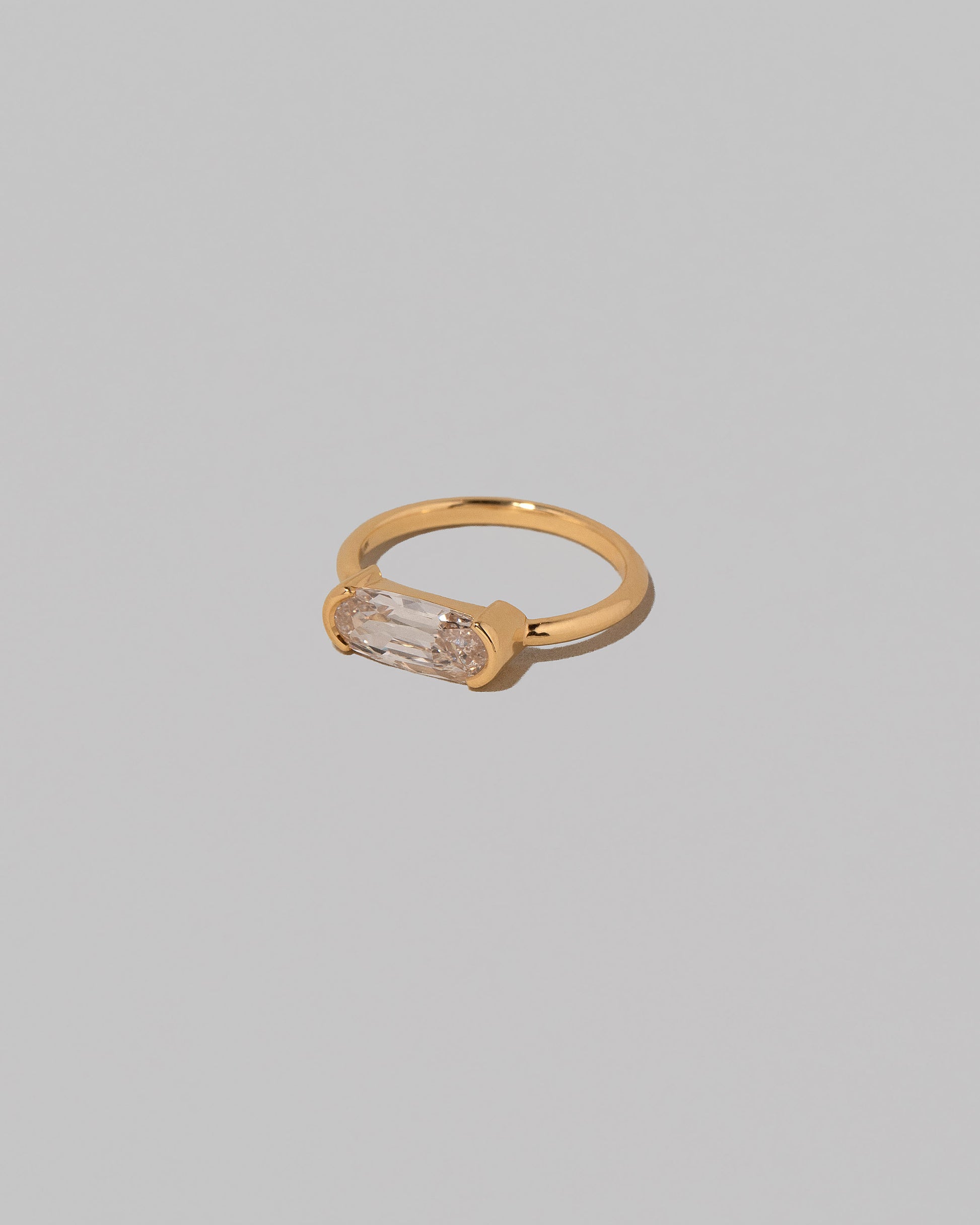 View from the side of the Moval Diamond Transformation Ring on light color background.