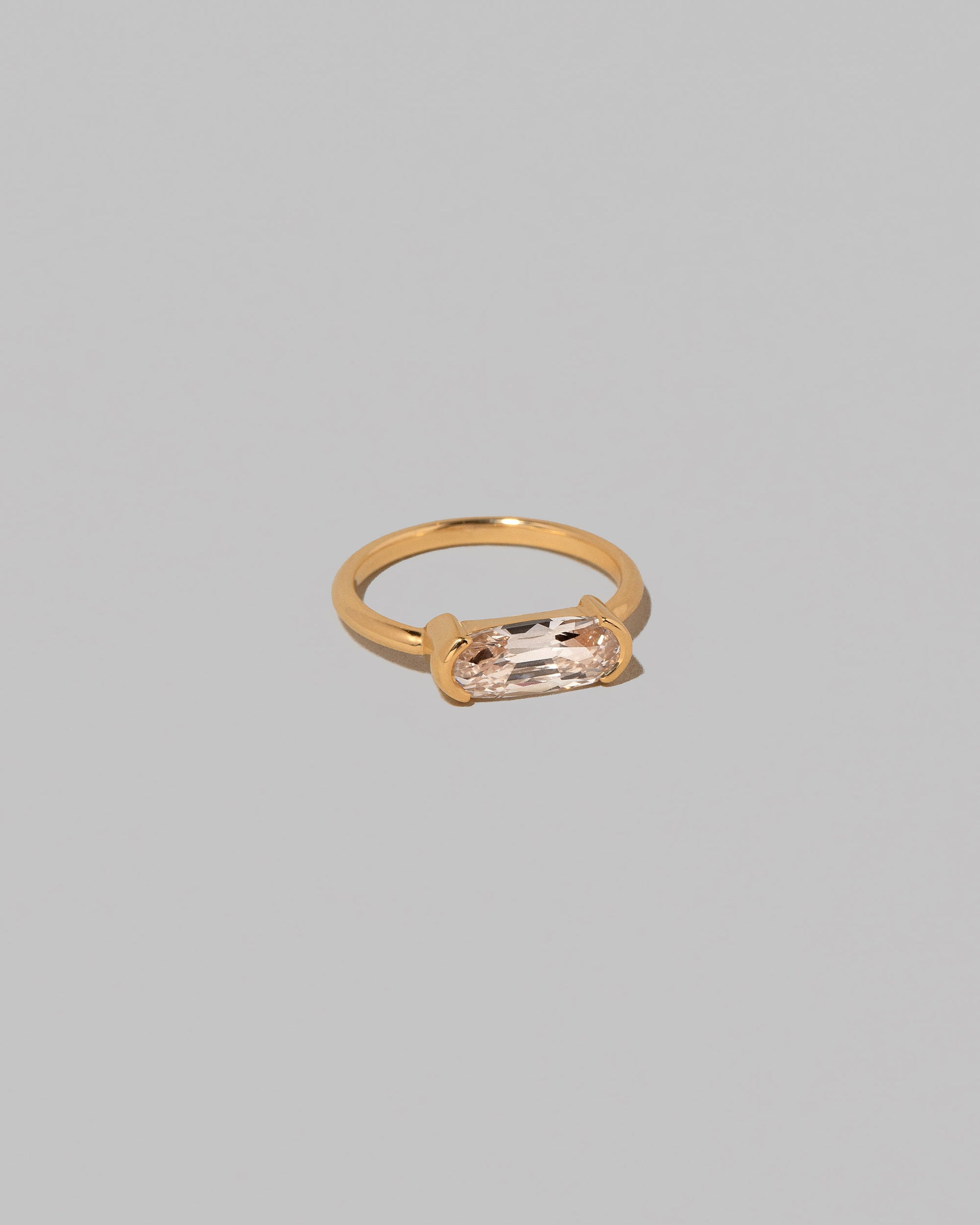 View from the side of the Moval Diamond Transformation Ring on light color background.