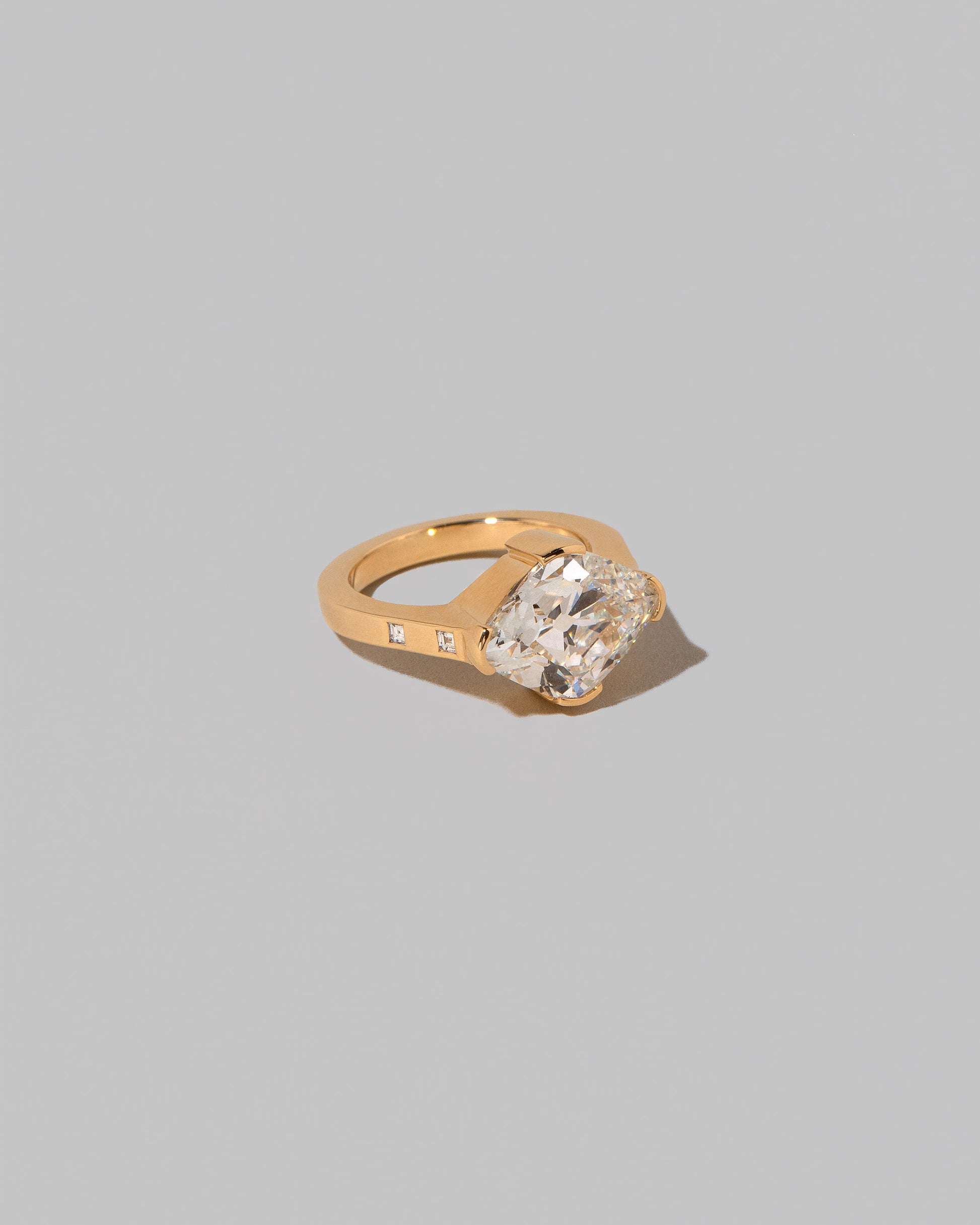 View from the side of the Narcissus Ring on light color background.