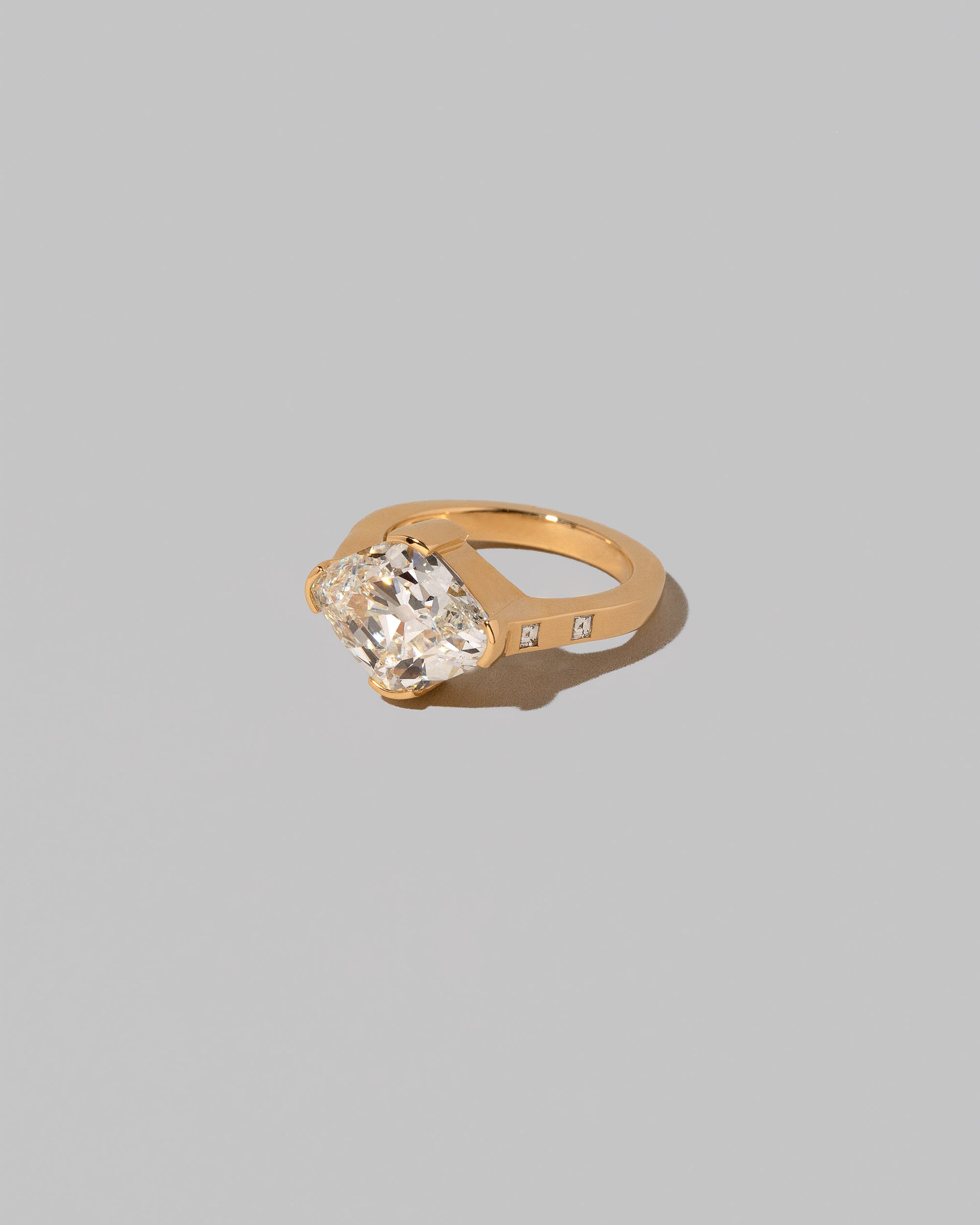 View from the side of the Narcissus Ring on light color background.
