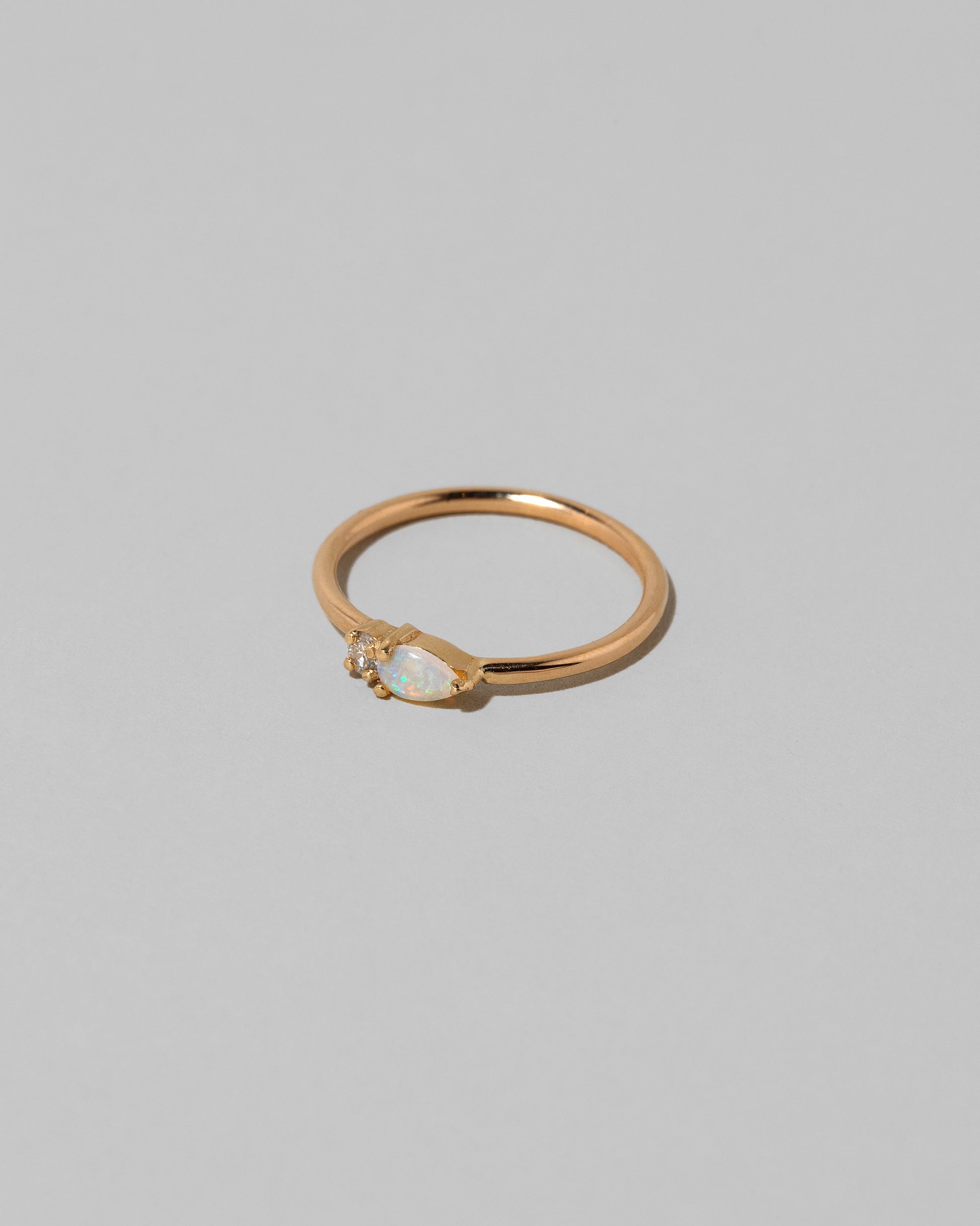 View from the side of the Opal Teardrops Ring on light color background.