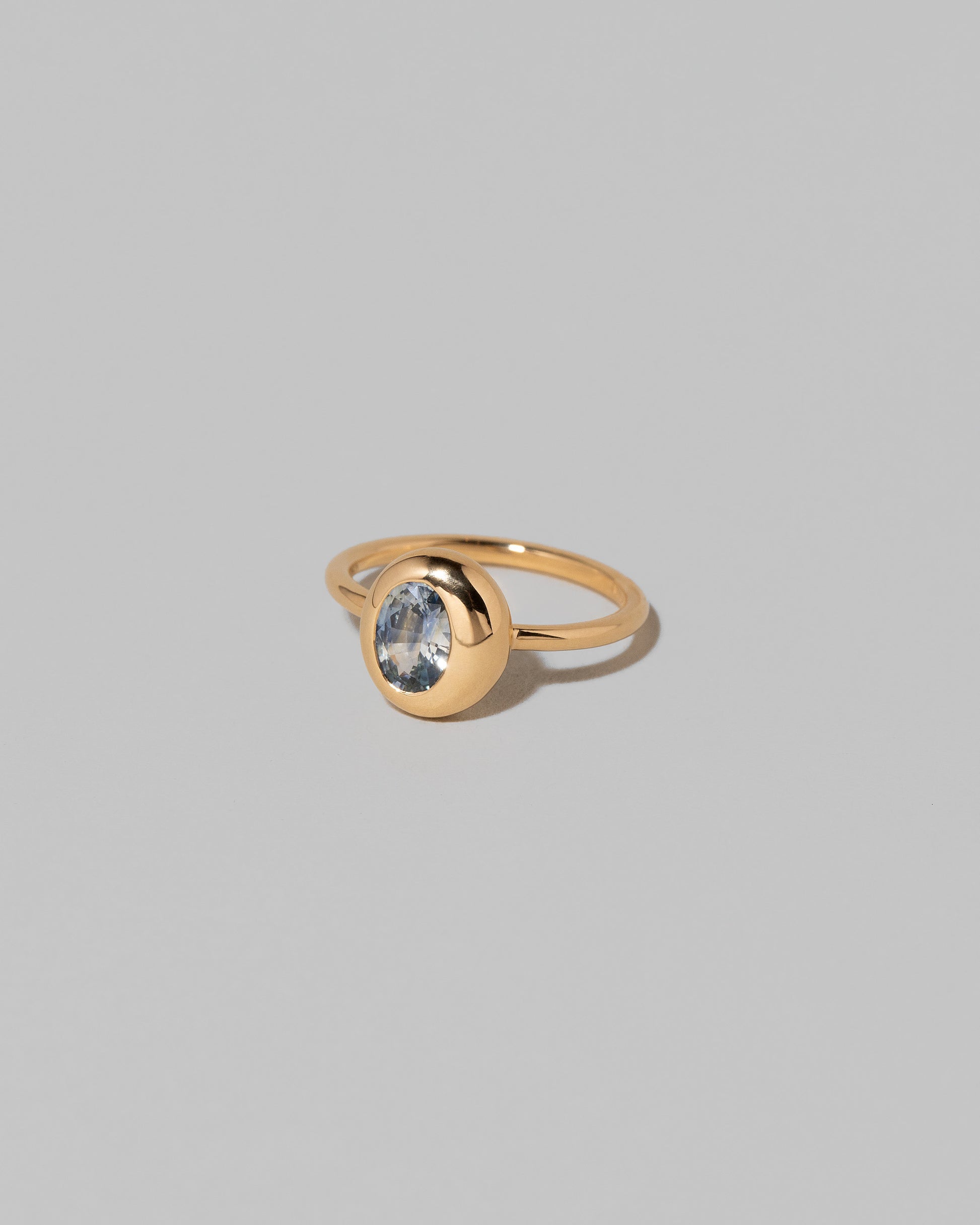 View from the side of the Oval Bicolor Sapphire Precise Ring on light color background.