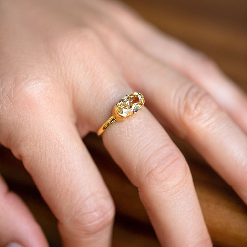 product_details::Oval Brown Diamond Transformation Ring on model.