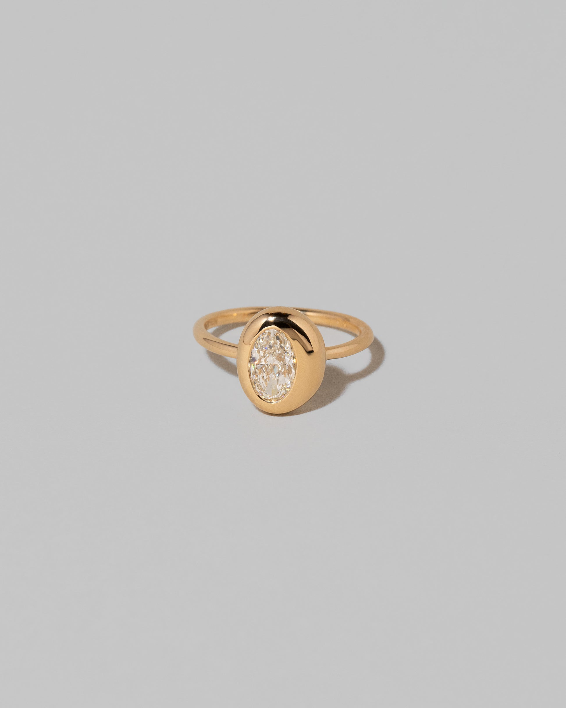 Oval Diamond Precise Ring on light color background.