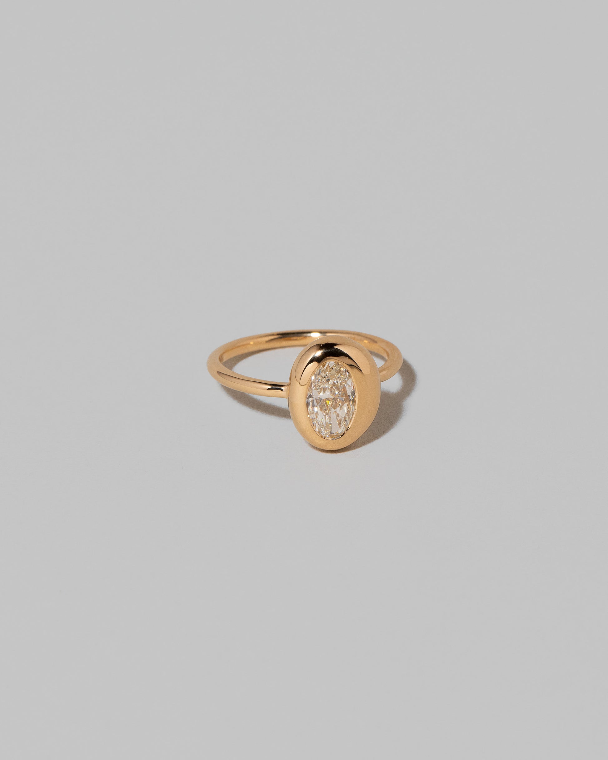 View from the side of the Oval Diamond Precise Ring on light color background.