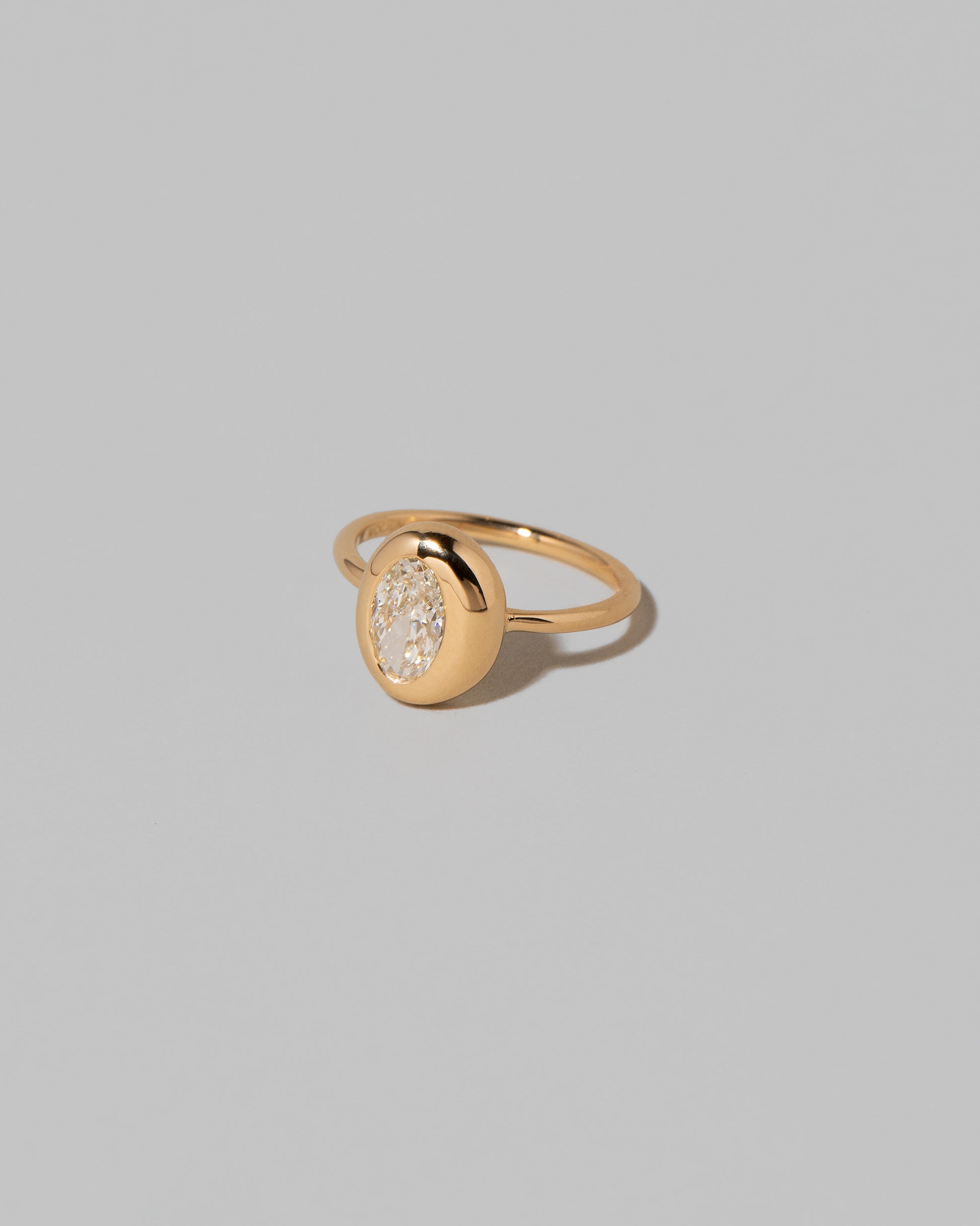 View from the side of the Oval Diamond Precise Ring on light color background.