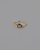 Oval Blue Sapphire Equalize Ring on light color background.