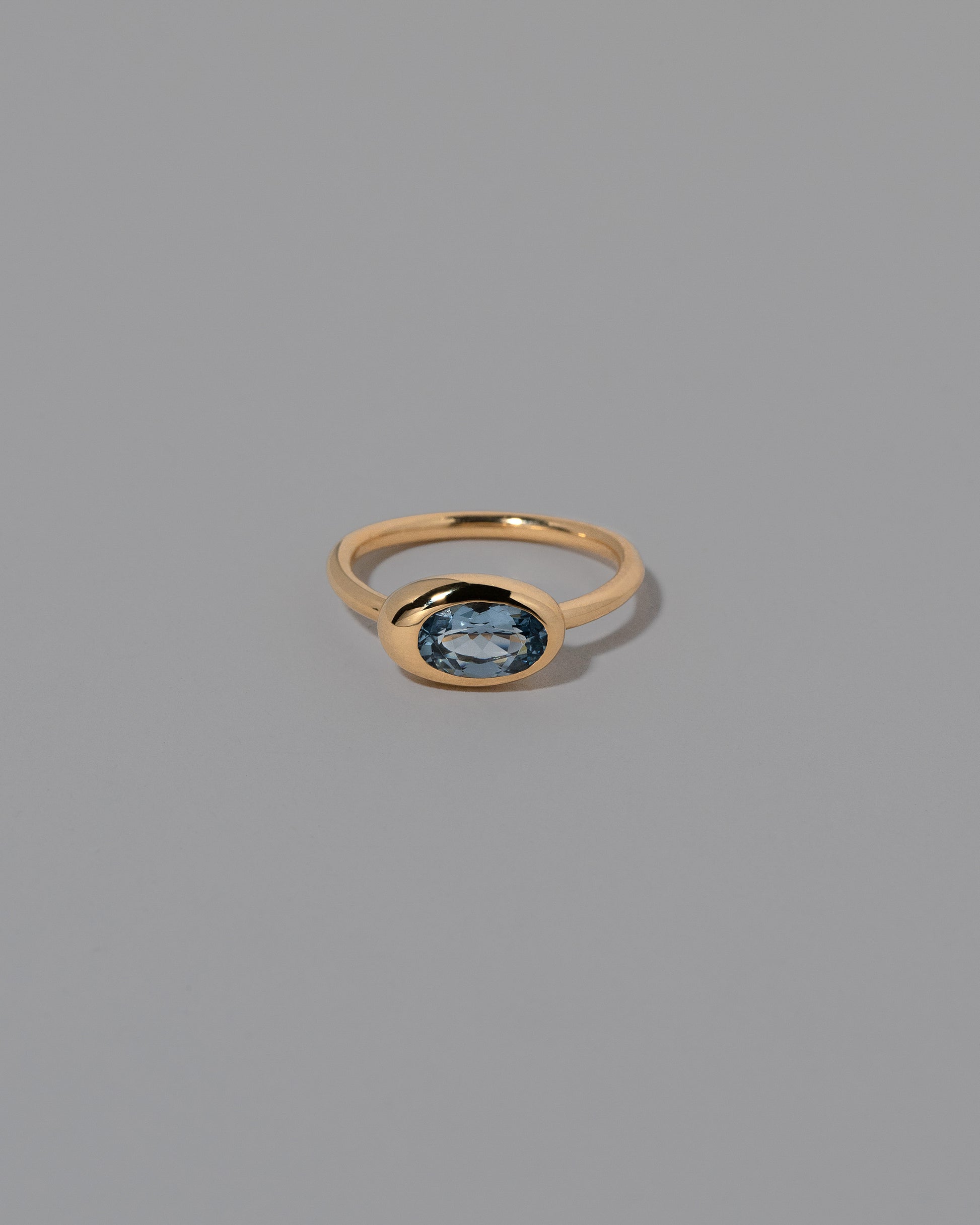 Oval Blue Sapphire Equalize Ring on light color background.