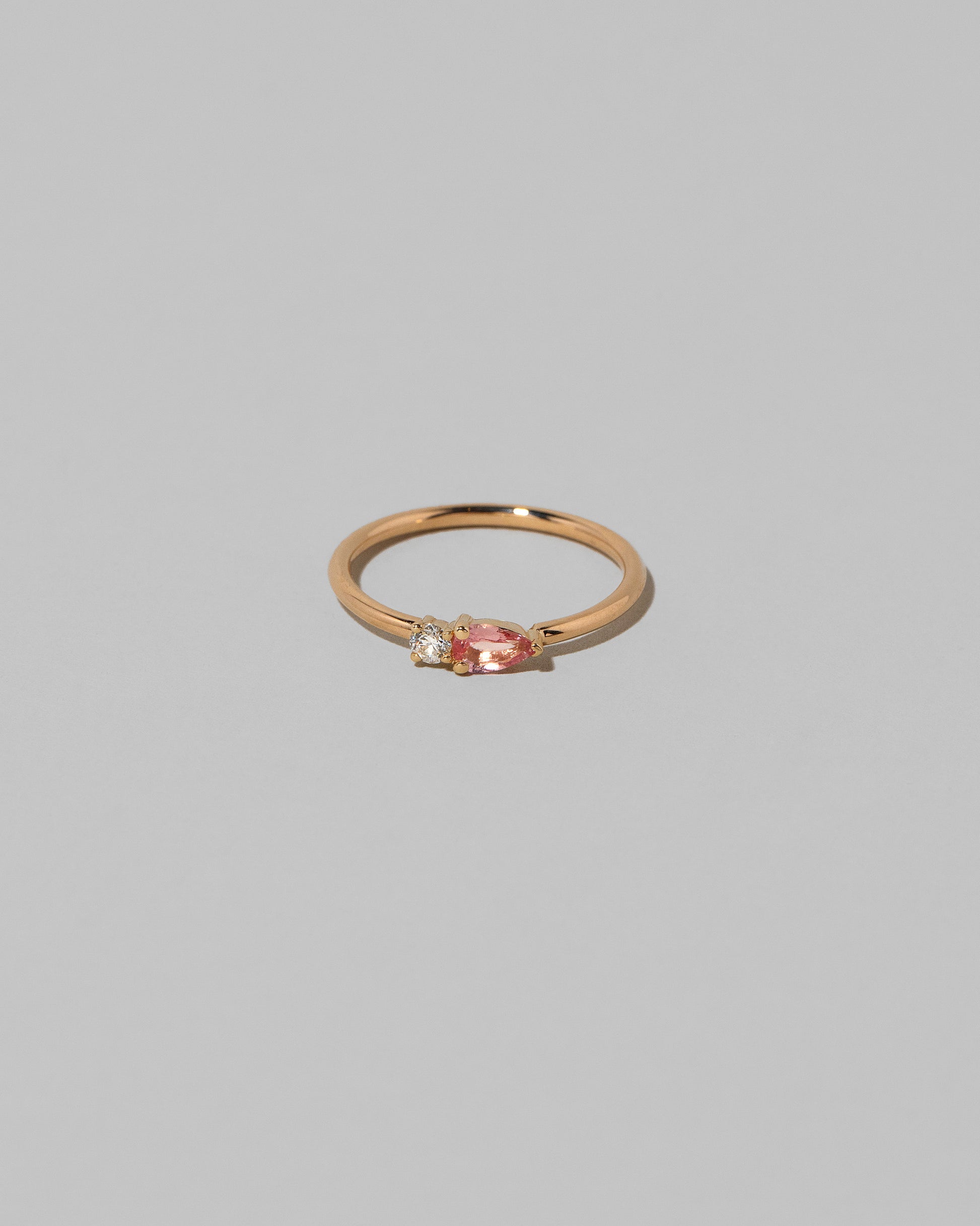 Peach Sapphire Teardrops Ring on light color background.