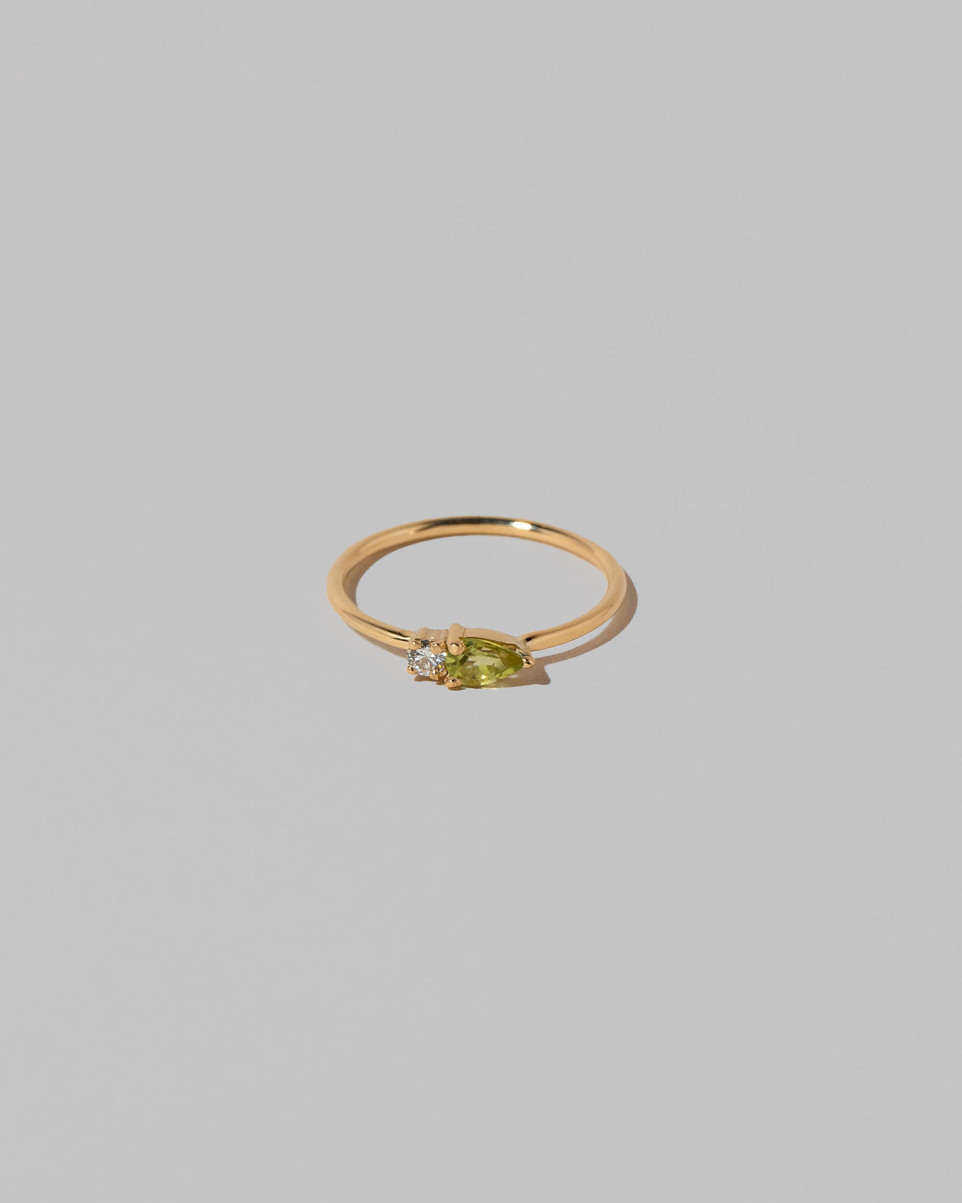 Peridot Teardrops Ring on light color background.