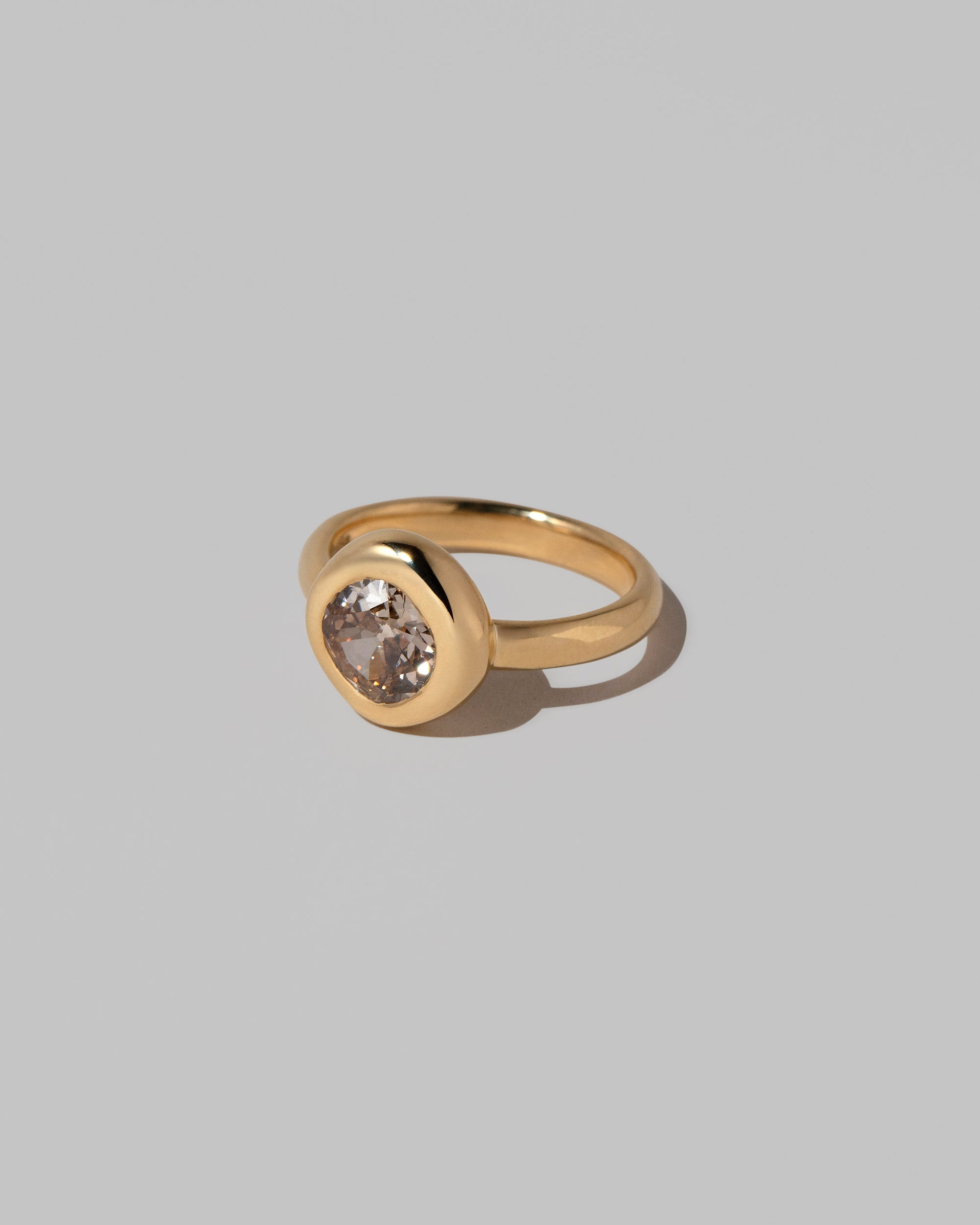 View from the side of the Brown Diamond Poise Ring on light color background.