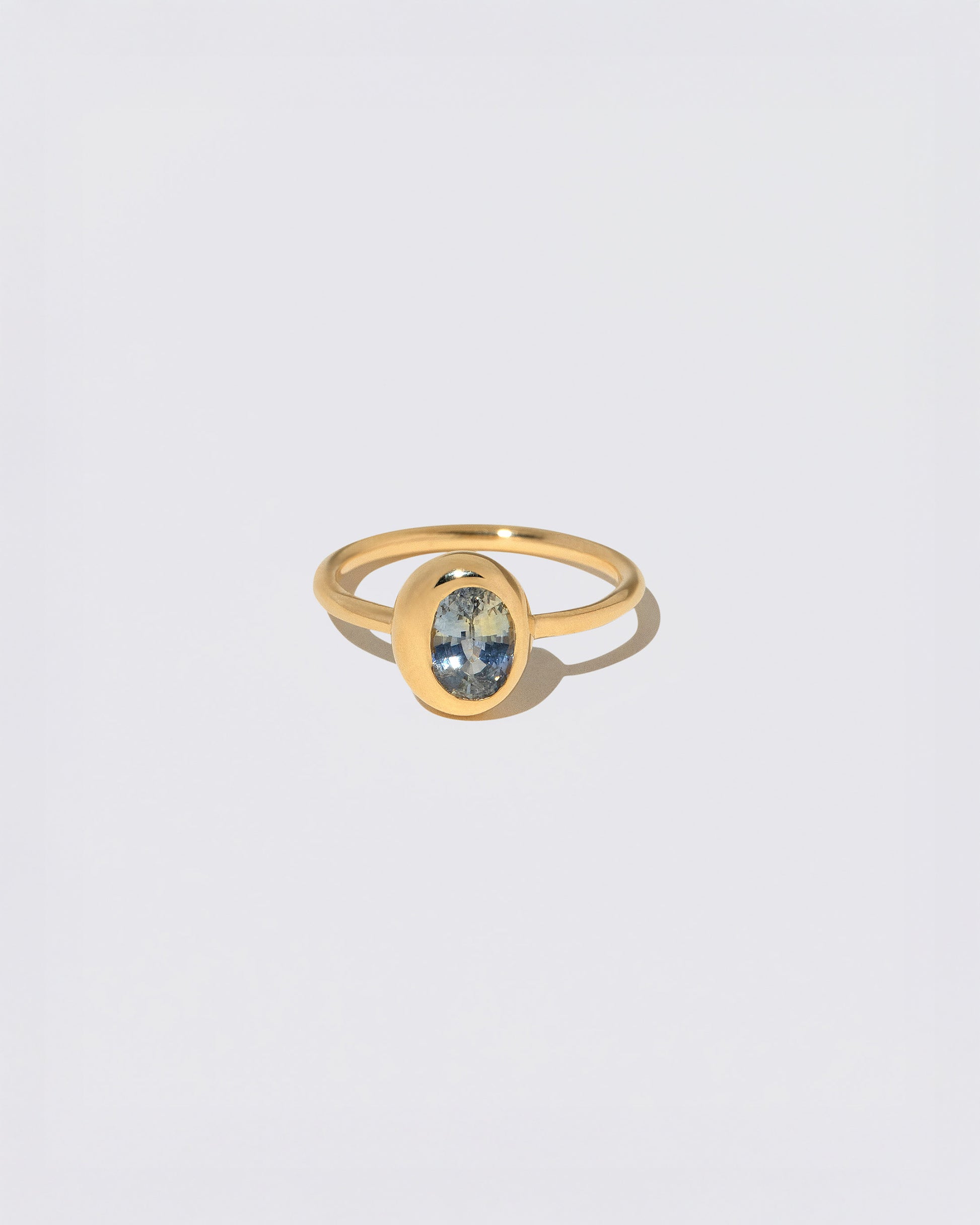 Oval Bicolor Sapphire Precise Ring on light color background.