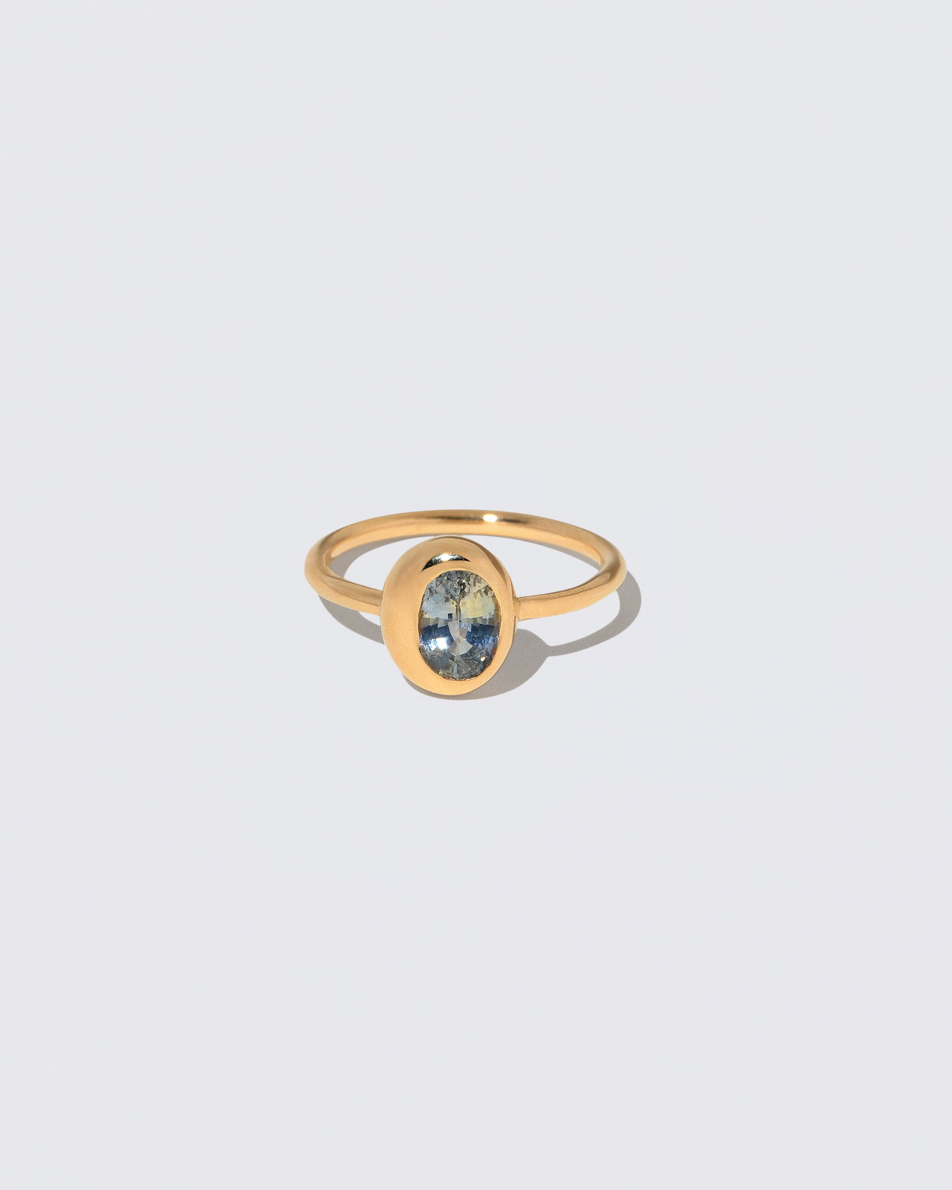 Oval Bicolor Sapphire Precise Ring on light color background.