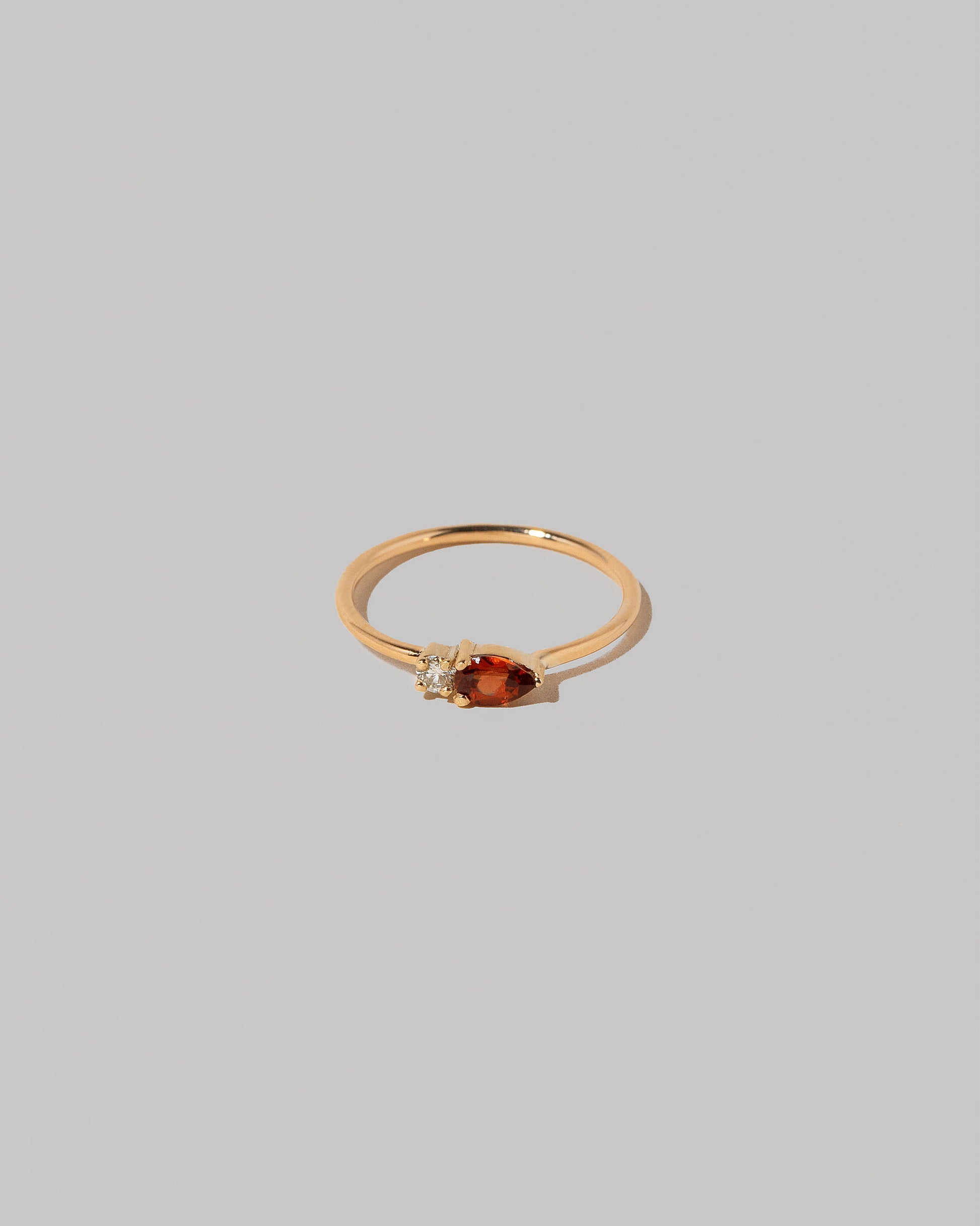Red Garnet Teardrops Ring on light color background.