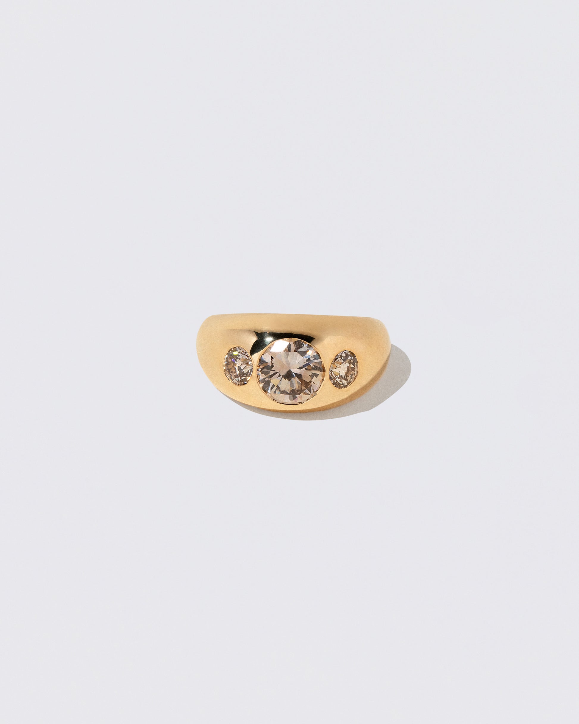 Champagne Diamond Saturn Ring on light color background.
