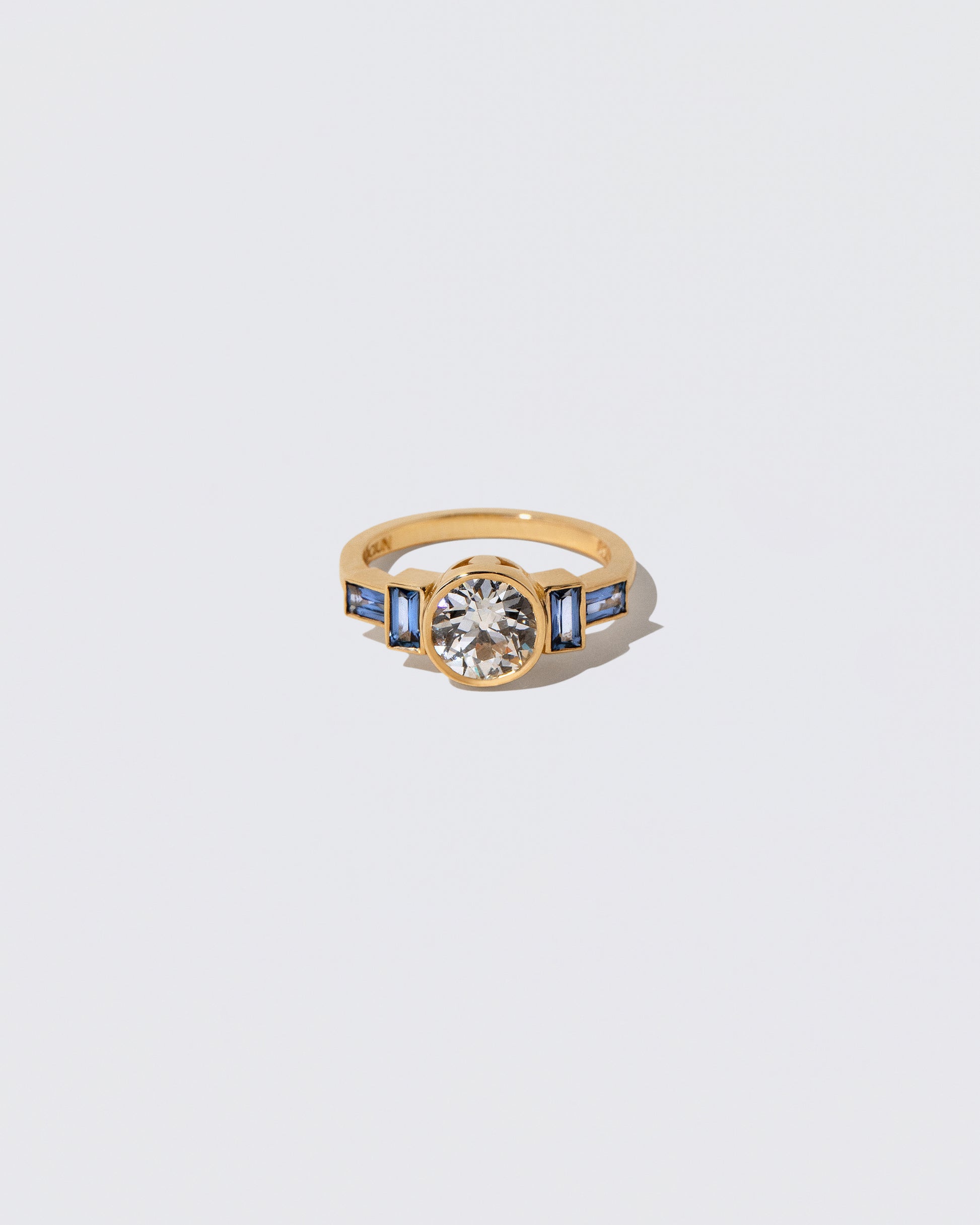 White Diamond & Blue Sapphire Third Eye Ring on light color background.