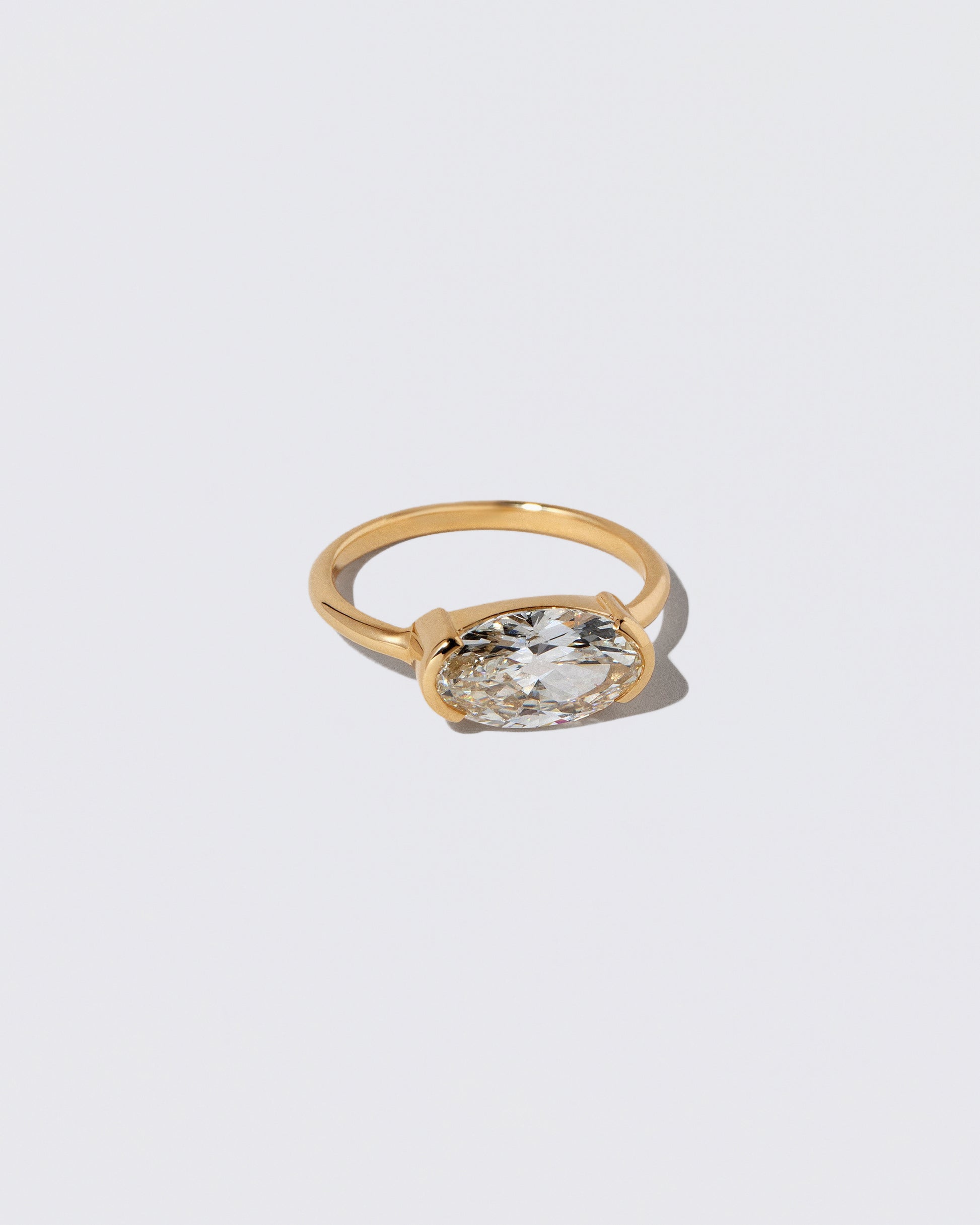 View from the side of the Moval Diamond Transformation Ring on light color background.