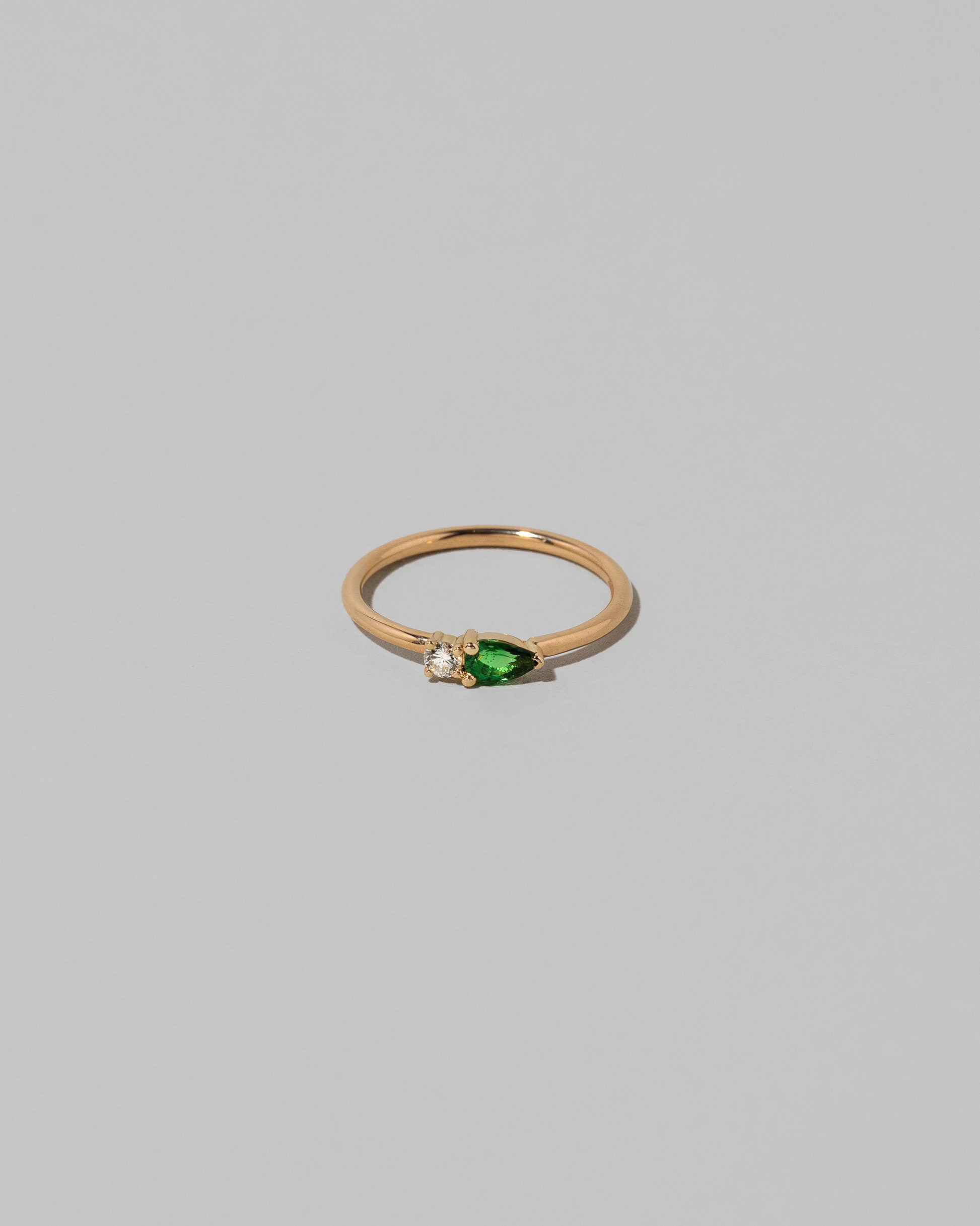 Tsavorite Teardrops Ring on light color background.