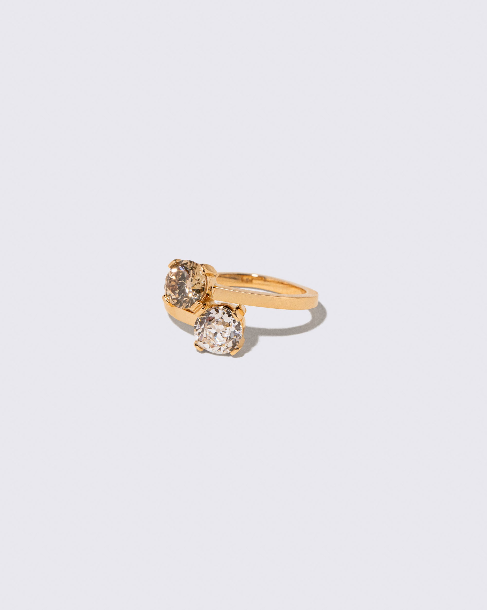 View from the side of the Champagne & White Diamond Union Ring on light color background.