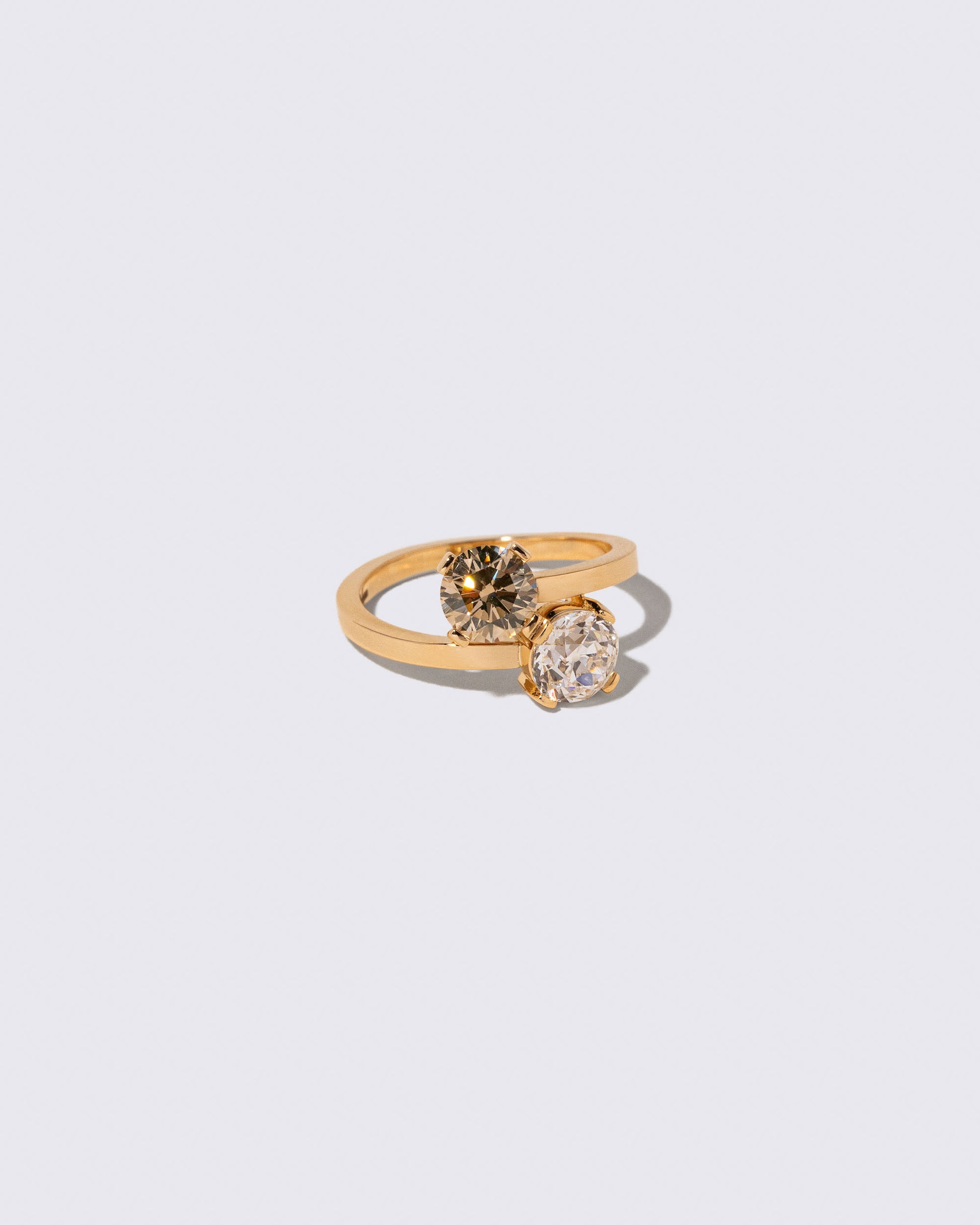 View from the side of the Champagne & White Diamond Union Ring on light color background.