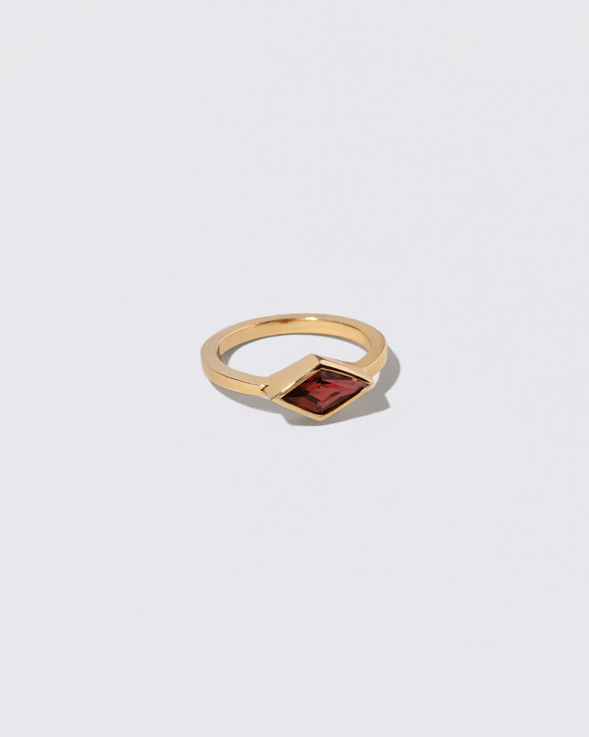 View from the side of the Warmhearted Ring on light color background.