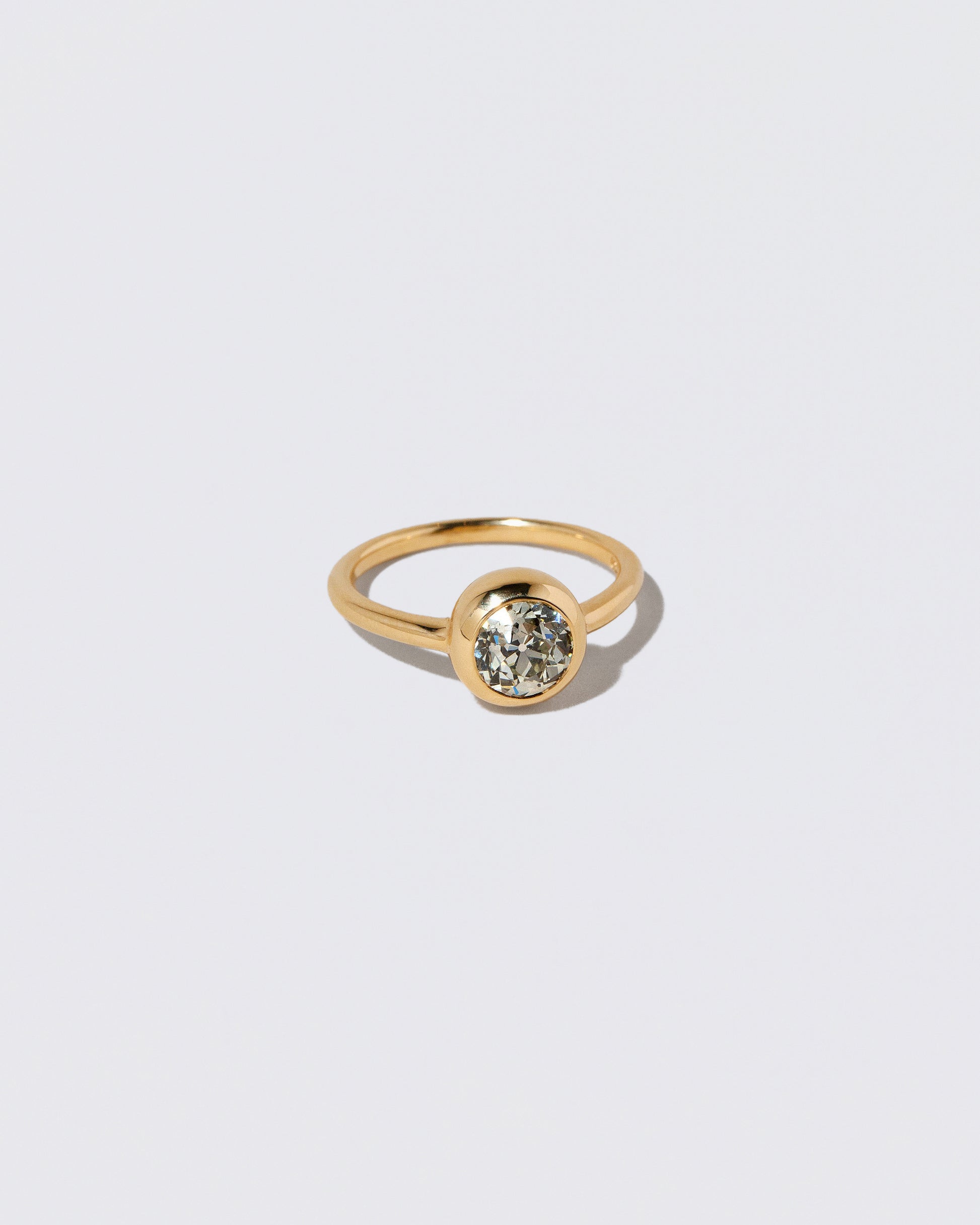 View from the side of a past version of the Diamond Wellspring Ring on light color background.