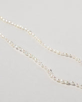 Closeup details of the White Oval Pearl Bracelets on light color background.