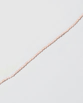 Closeup details of the Pink Peony Oval Seed Pearl Choker Necklace on light color background.