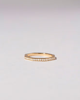 Gold Pavé 2mm Segmented Half Hoop Band on light color background.