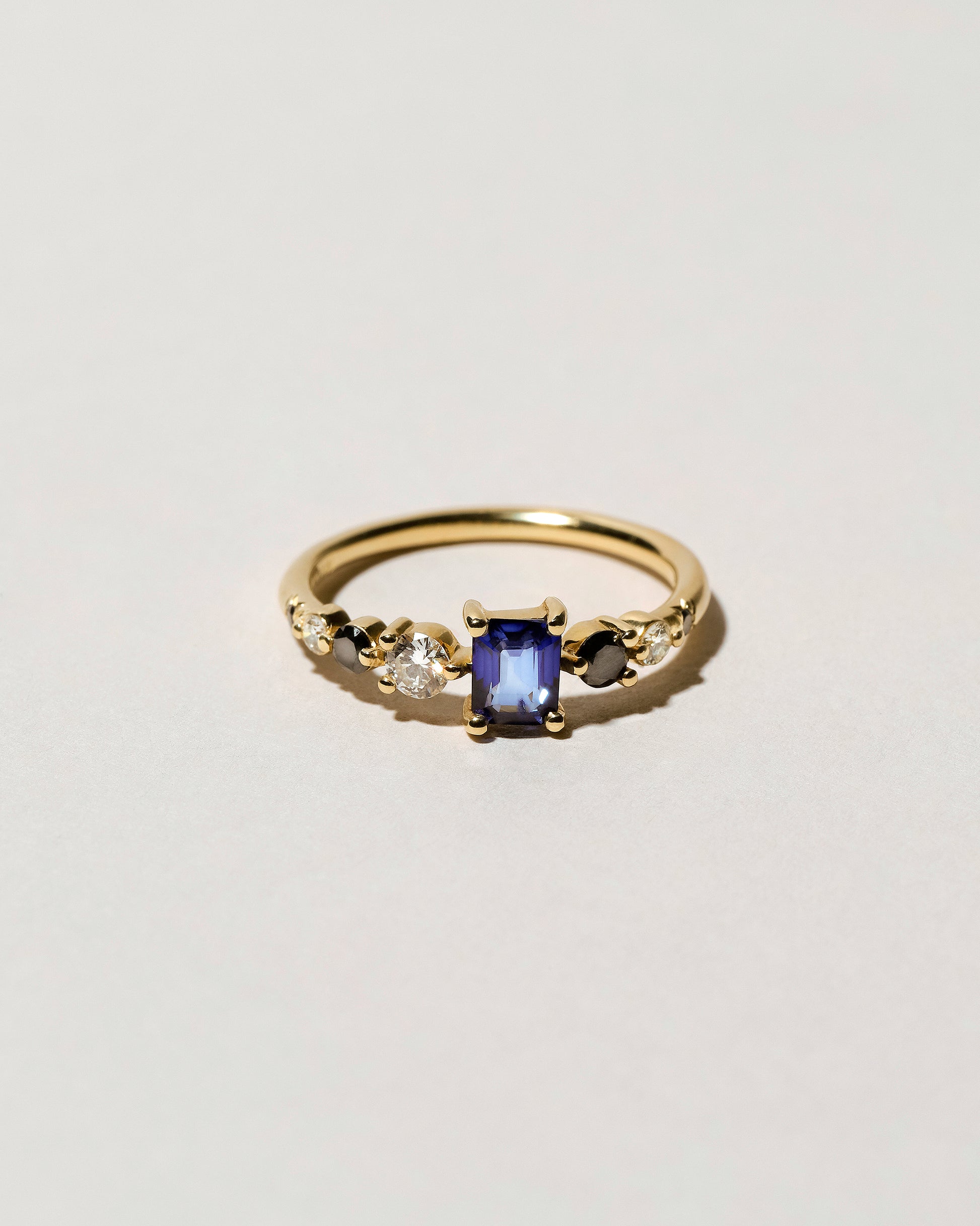 Sapphire Seven Sisters Ring on light color background.