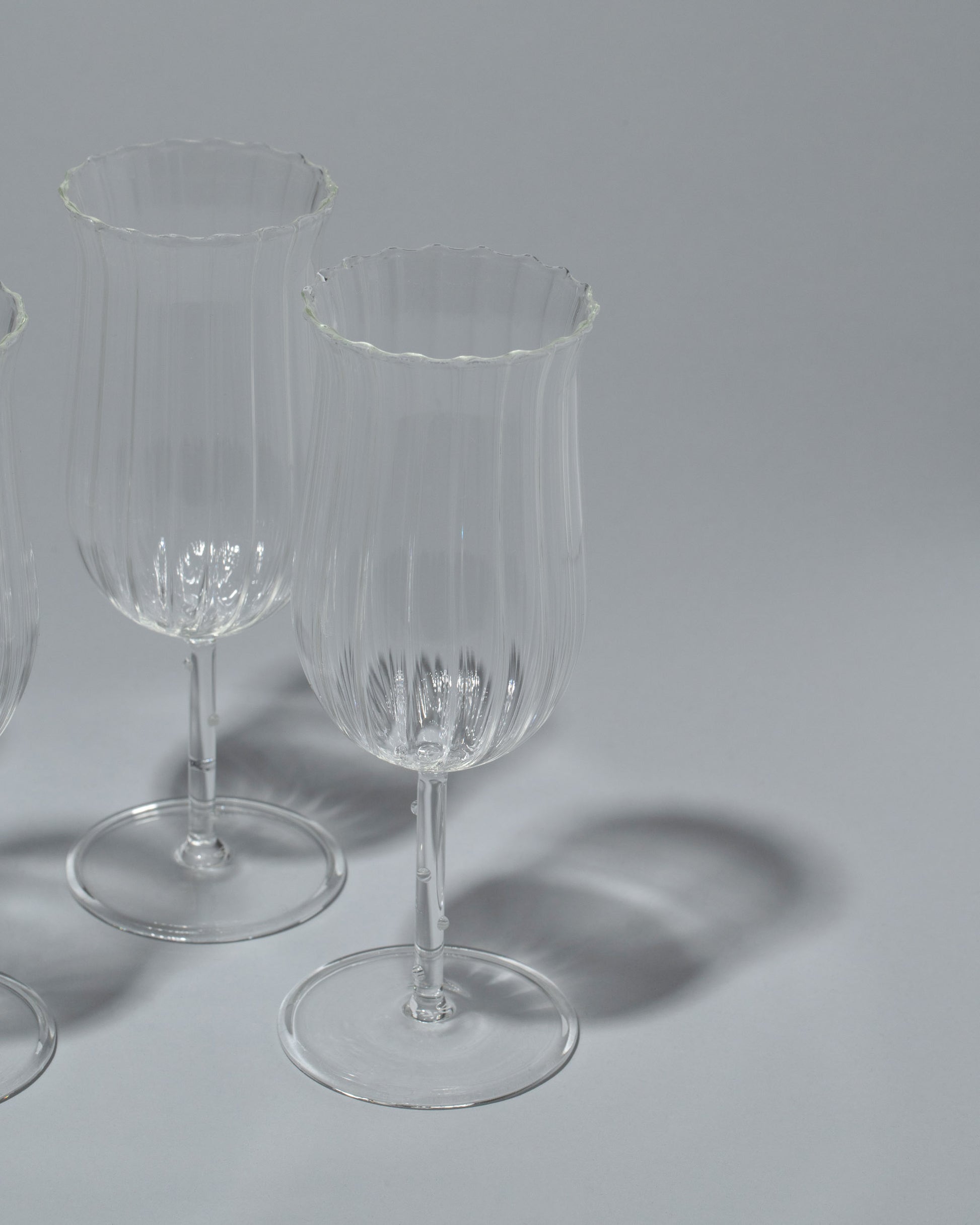 Closeup details of the Sophie Lou Jacobsen Tulip Wine Glass Set on light color background.