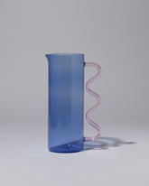 Sophie Lou Jacobsen Blue with Pink Handle Wave Pitcher on light color background.