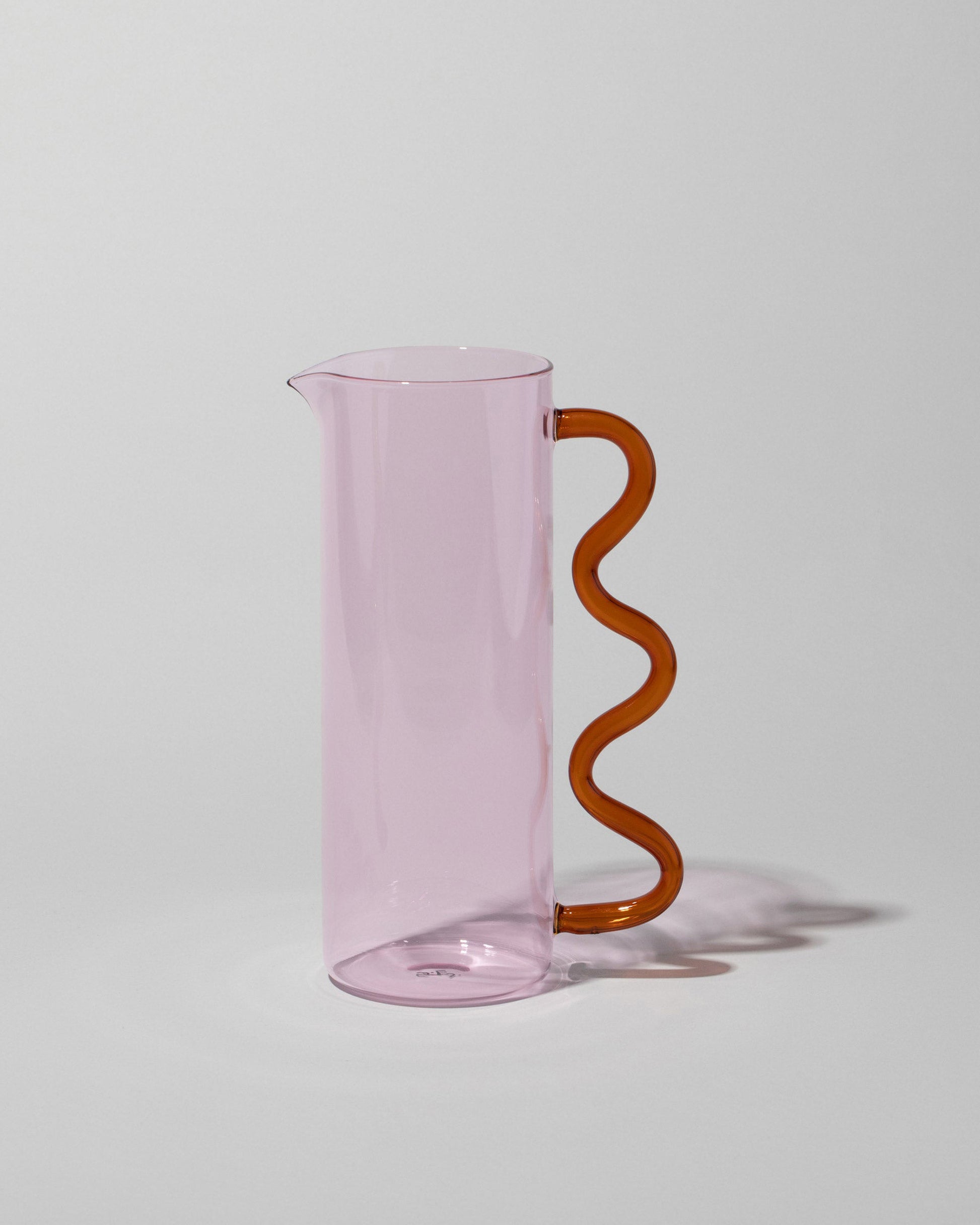 Sophie Lou Jacobsen Pink with Amber Handle Wave Pitcher on light color background.