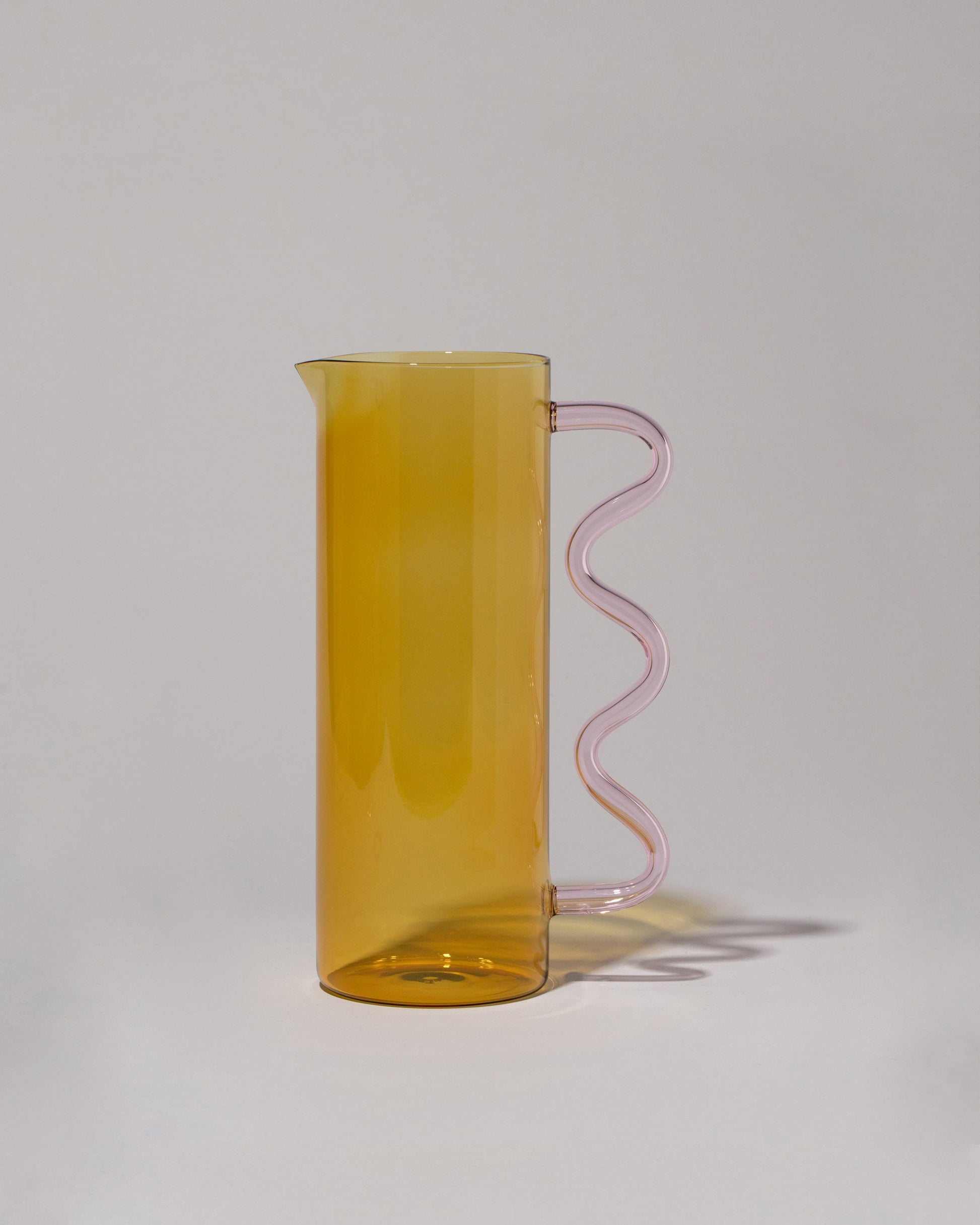 Sophie Lou Jacobsen Yellow with Pink Handle Wave Pitcher on light color background.