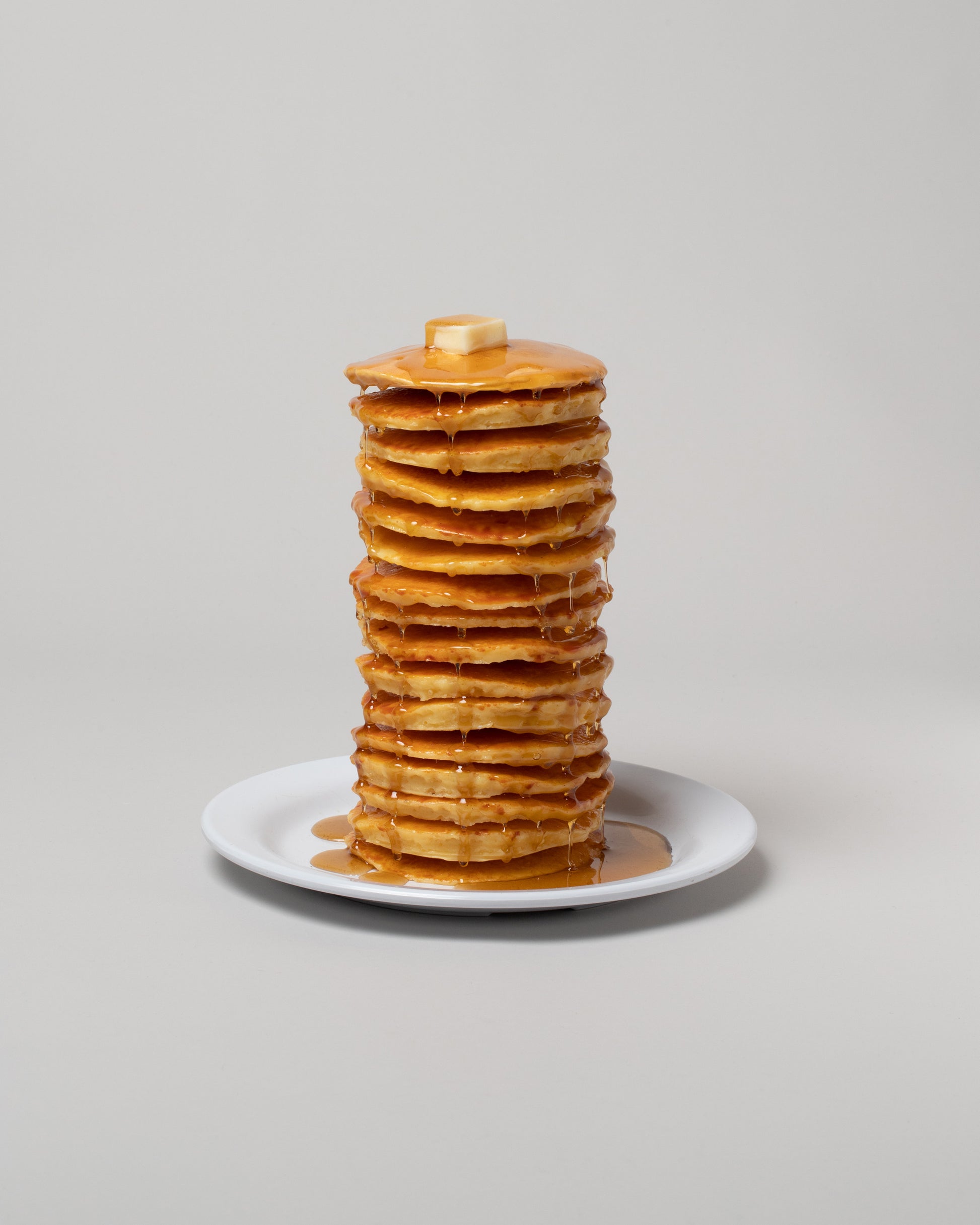Spills Tall Stack Pancakes & Waffles on light color background.