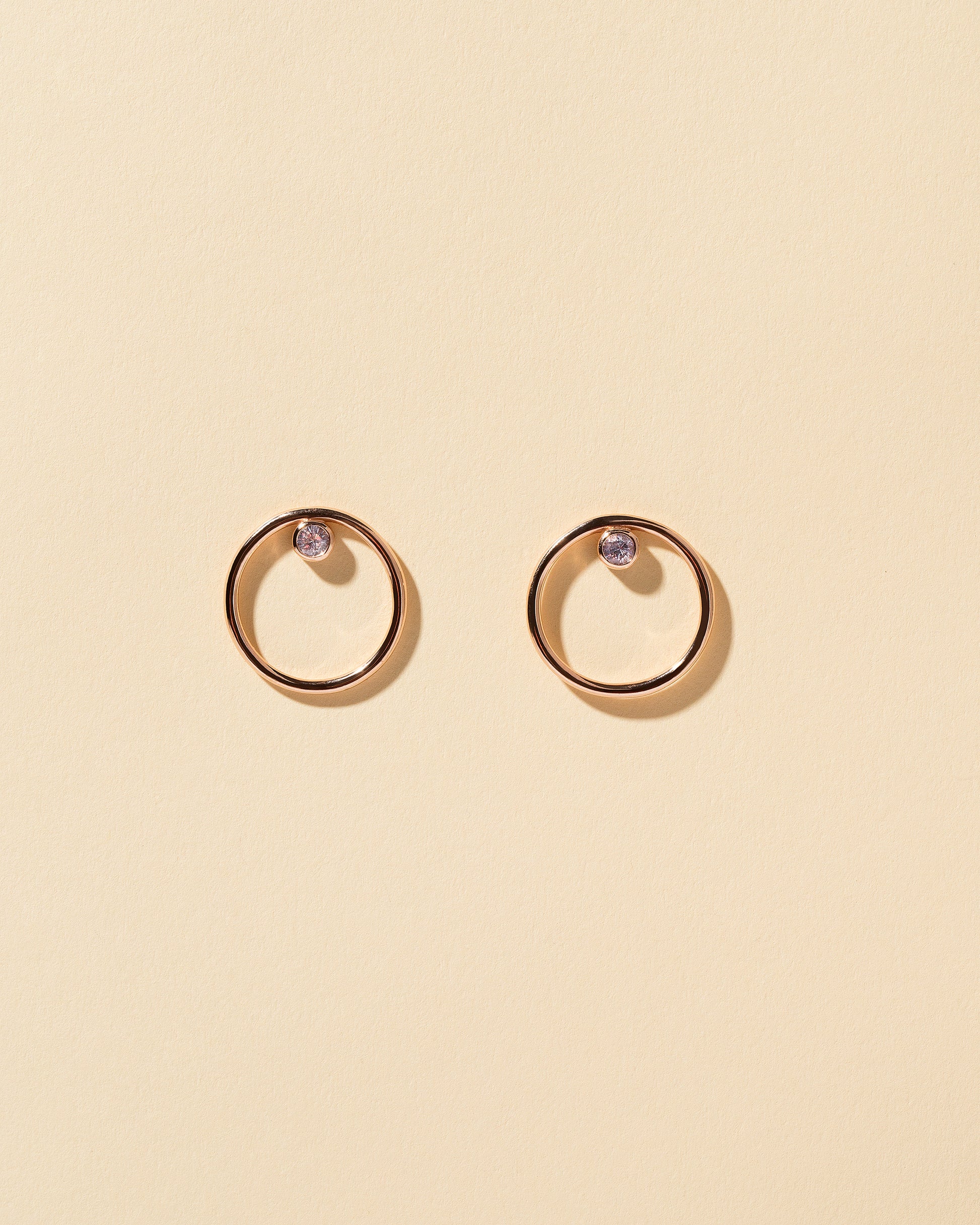 Spinel Rose Gold Coil Stud Earrings on yellow color background.