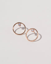 Spinel Rose Gold Coil Stud Earrings on light color background.