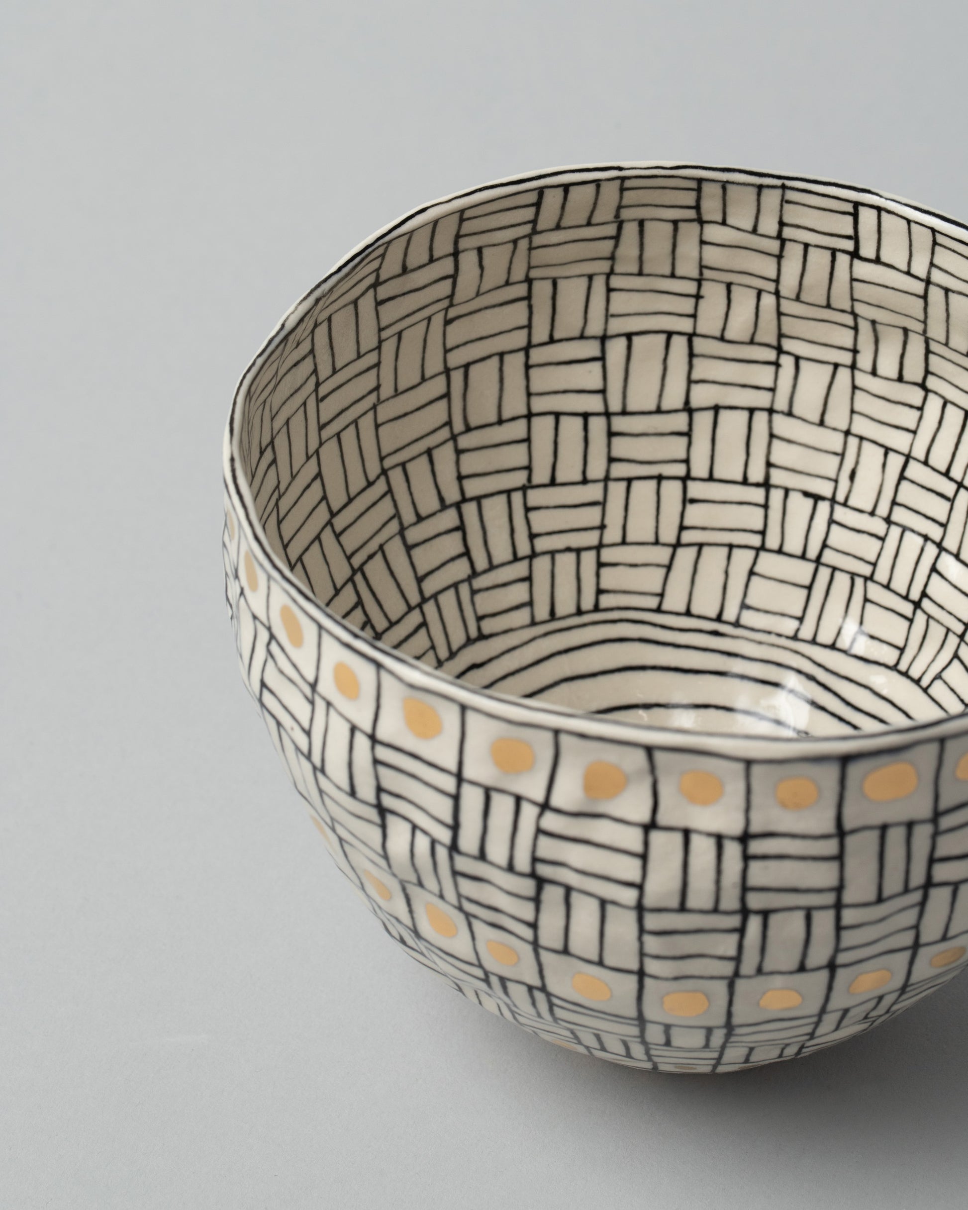Closeup detail of the Suzanne Sullivan Three Pinch Bowl on light color background.