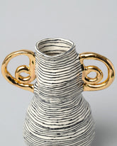 Closeup detail of the Suzanne Sullivan Vase With Gold Handles on light color background.