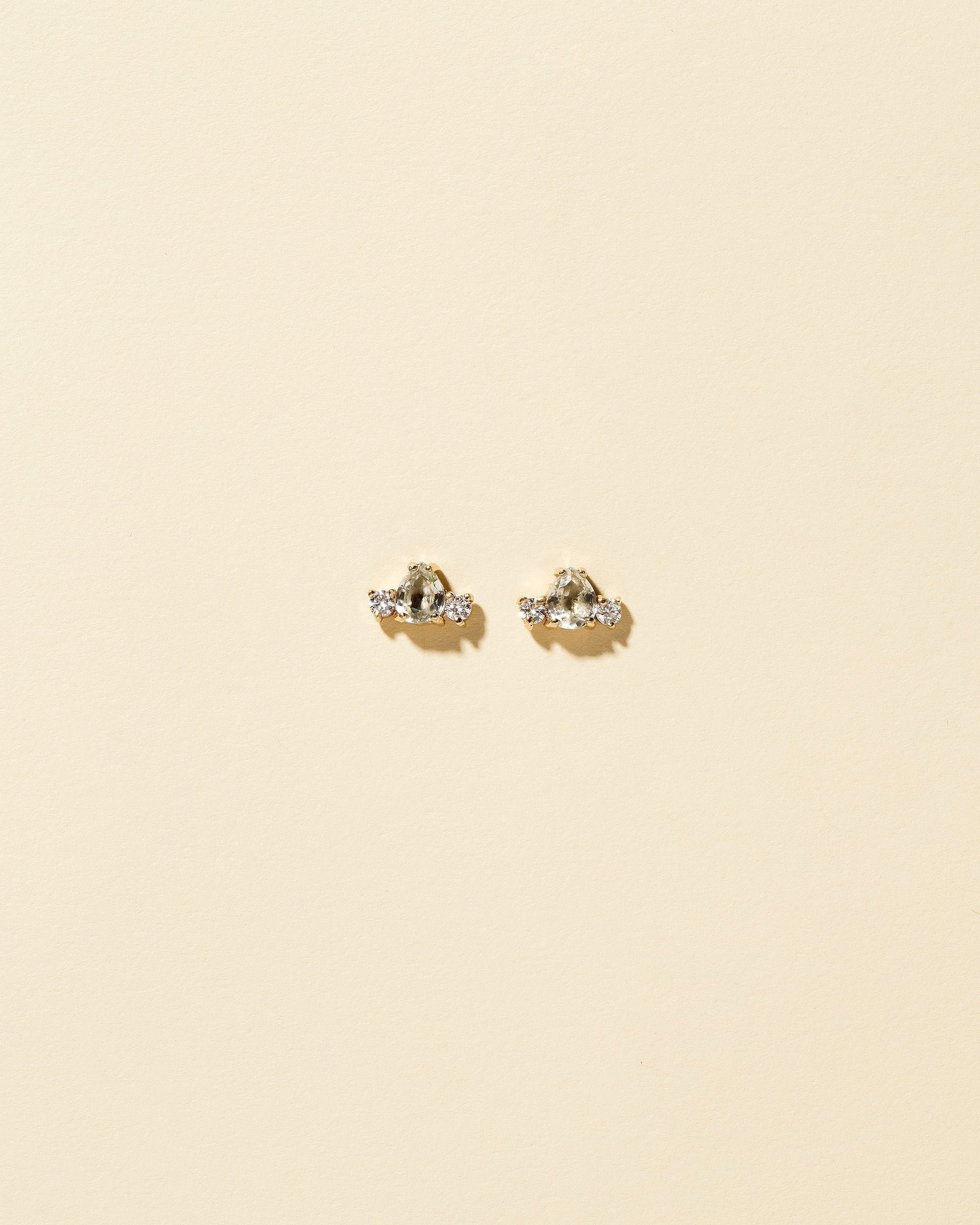 Tourmaline & Diamond Teardrop Earrings on light color background.