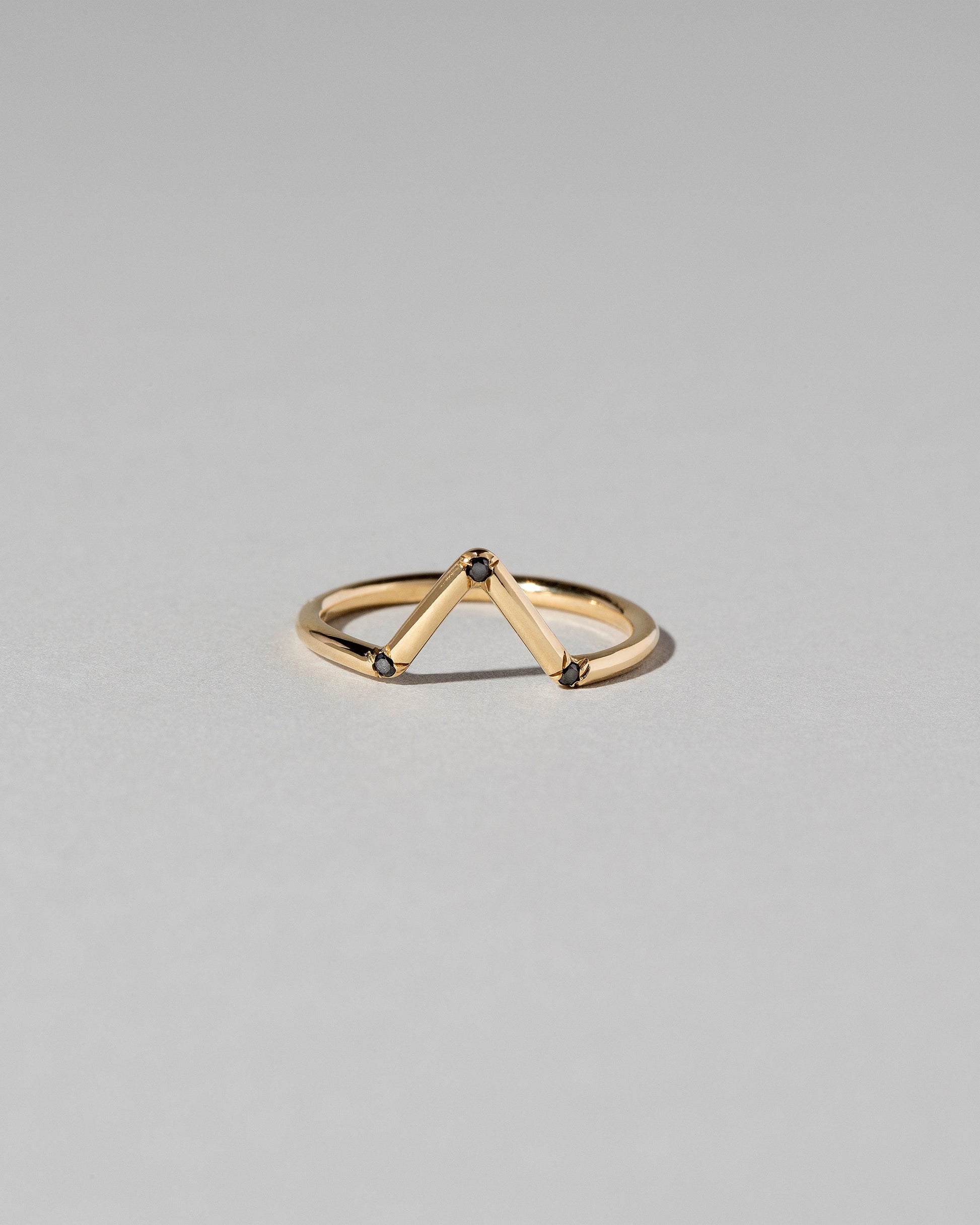 Gold Black Diamond Three Stone Triangle Band on light color background.