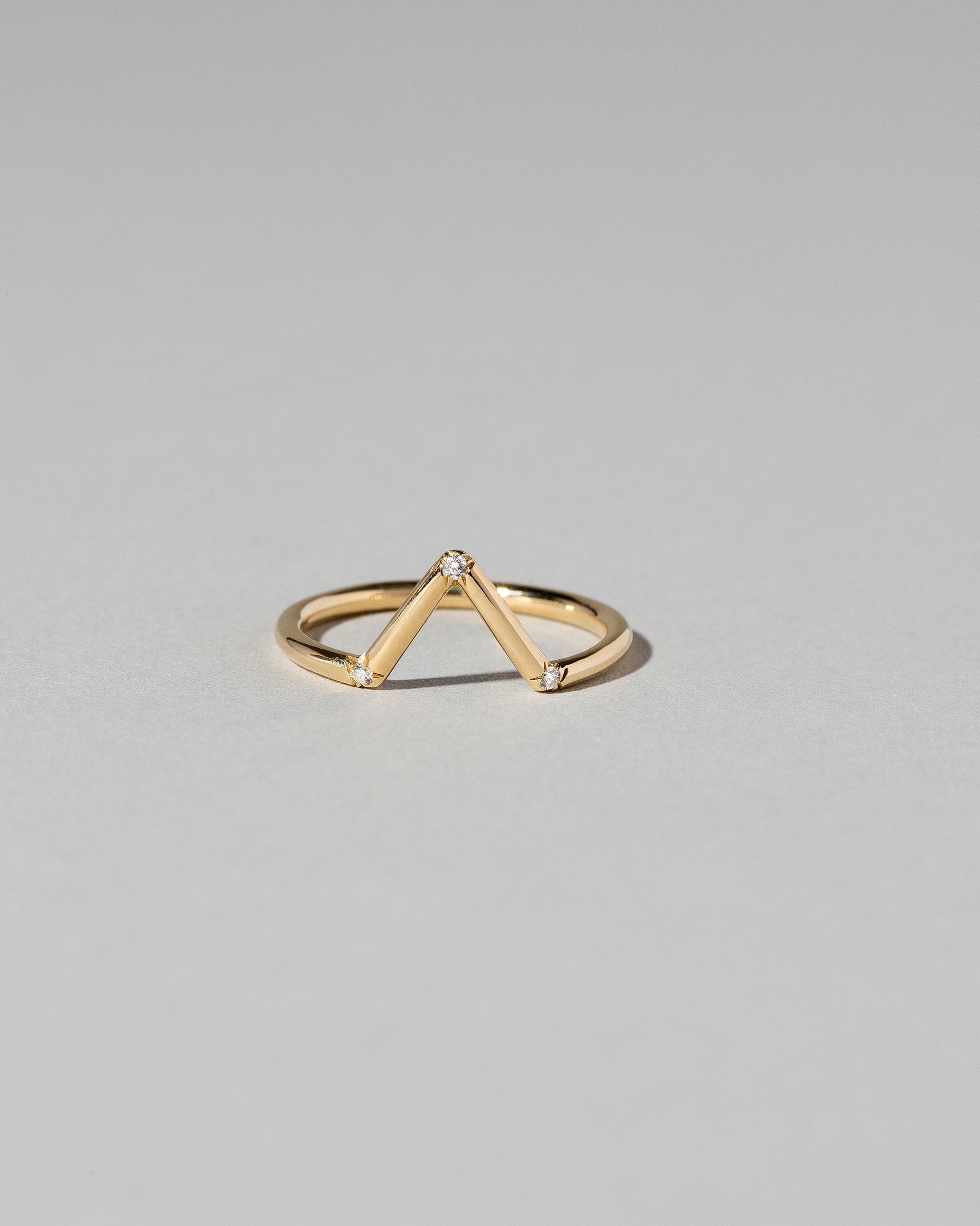 Gold White Diamond Three Stone Triangle Band on light color background.