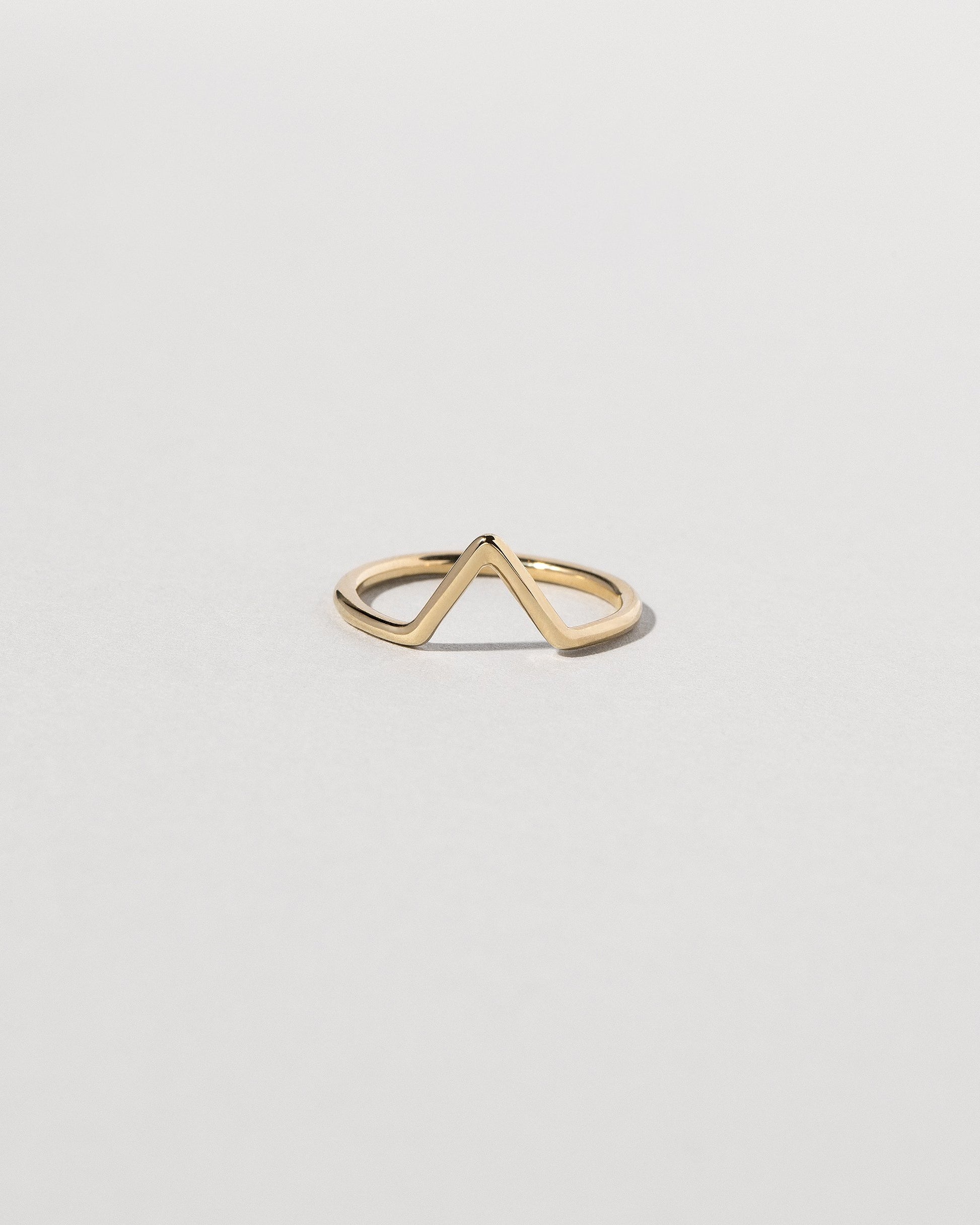 Gold Solid Round Wire Triangle Band on light color background.