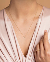 Gold White Diamond Triangle Necklace on model.