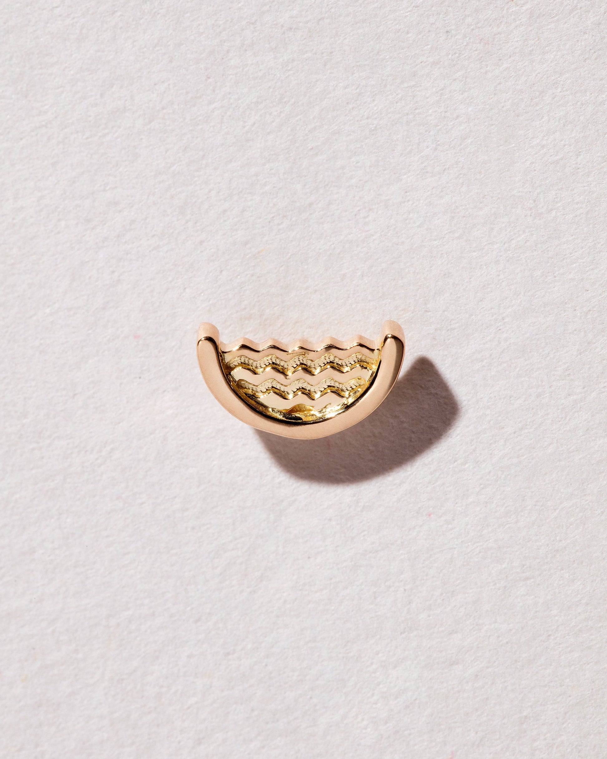Gold Water Talisman Stud Earring Single on light color background.