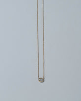 Samples & Imperfects 14k Yellow Gold Moonstone Pendant Level Necklace on light color background.