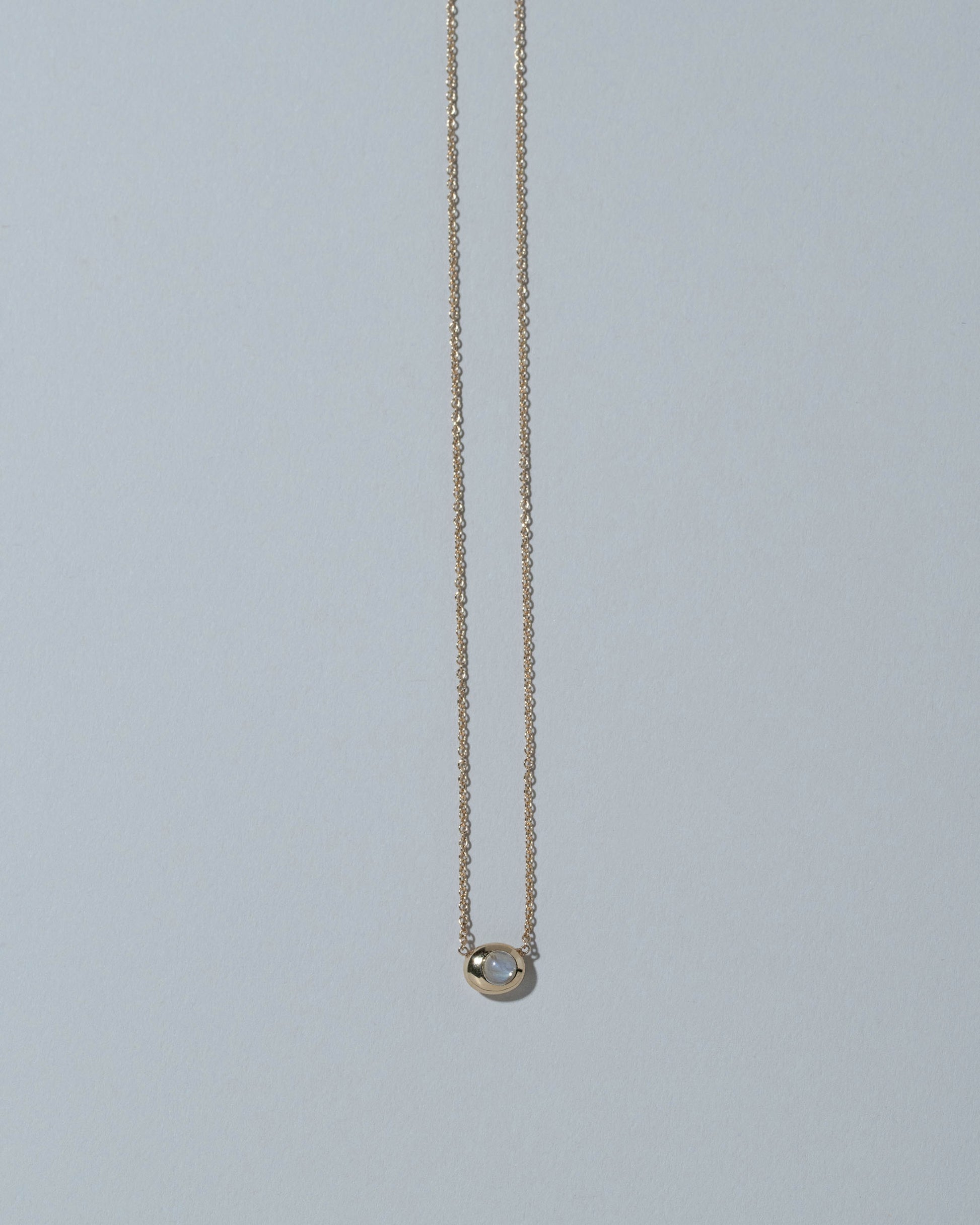 Samples & Imperfects 14k Yellow Gold Moonstone Pendant Level Necklace on light color background.