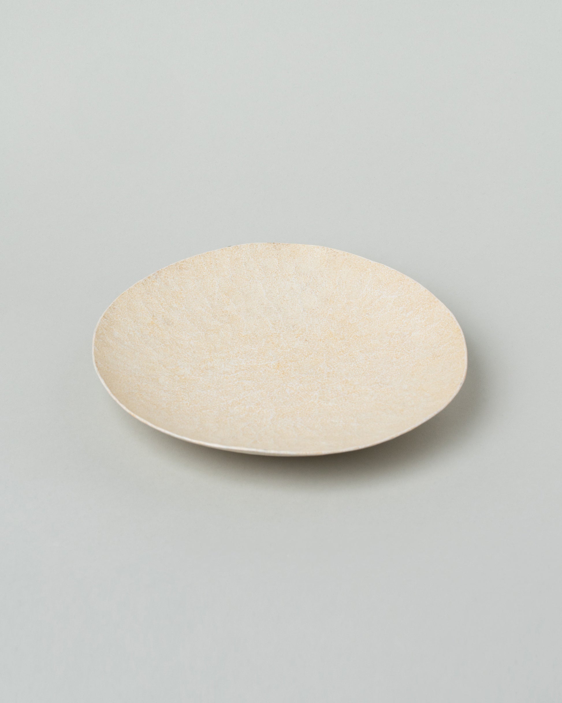 Closeup details of the Namu Home Goods Cream Mini Maple Wood Whittled Plate on light color background.