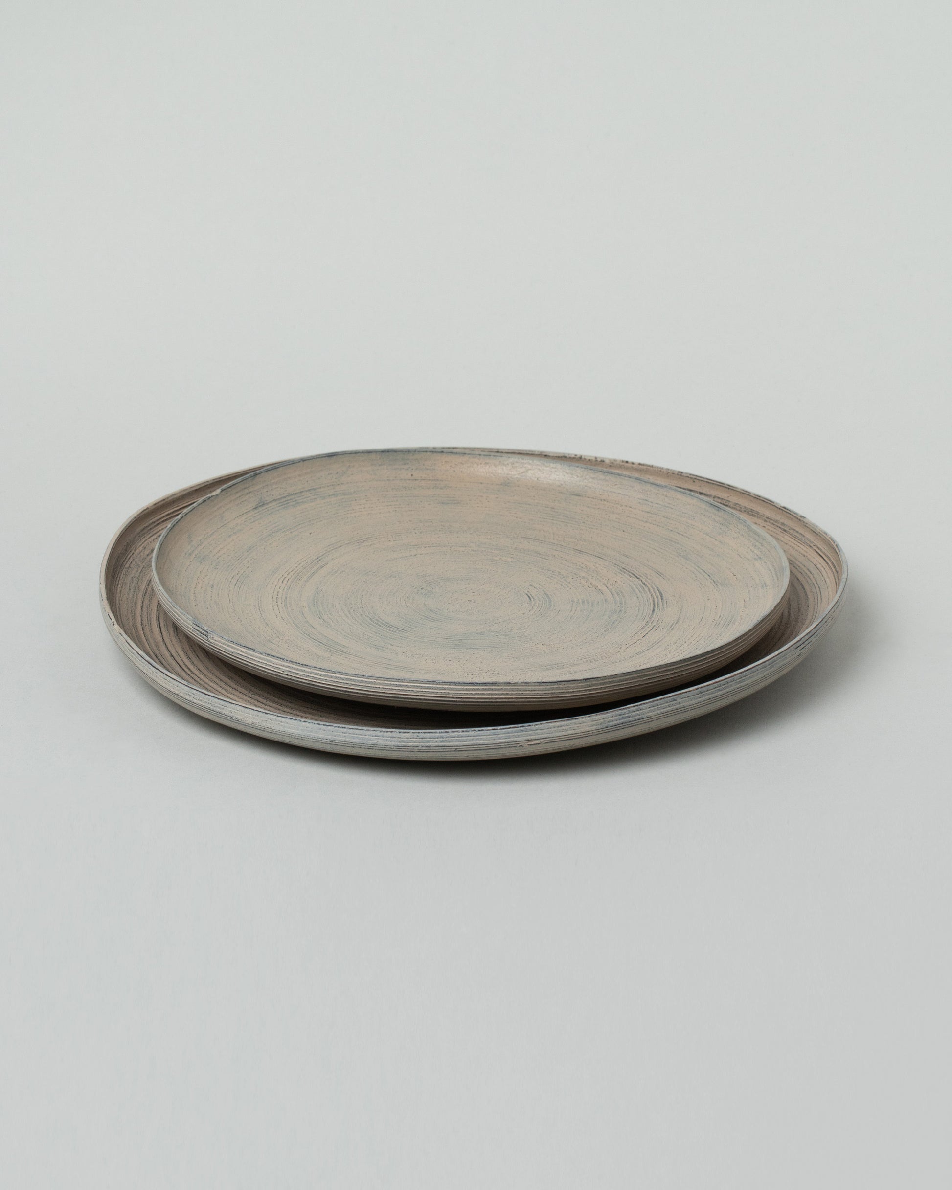 Namu Home Goods Large Zelkova Wood Winter Organic Plate and Namu Home Goods Small Zelkova Wood Winter Organic Plate on light color background.